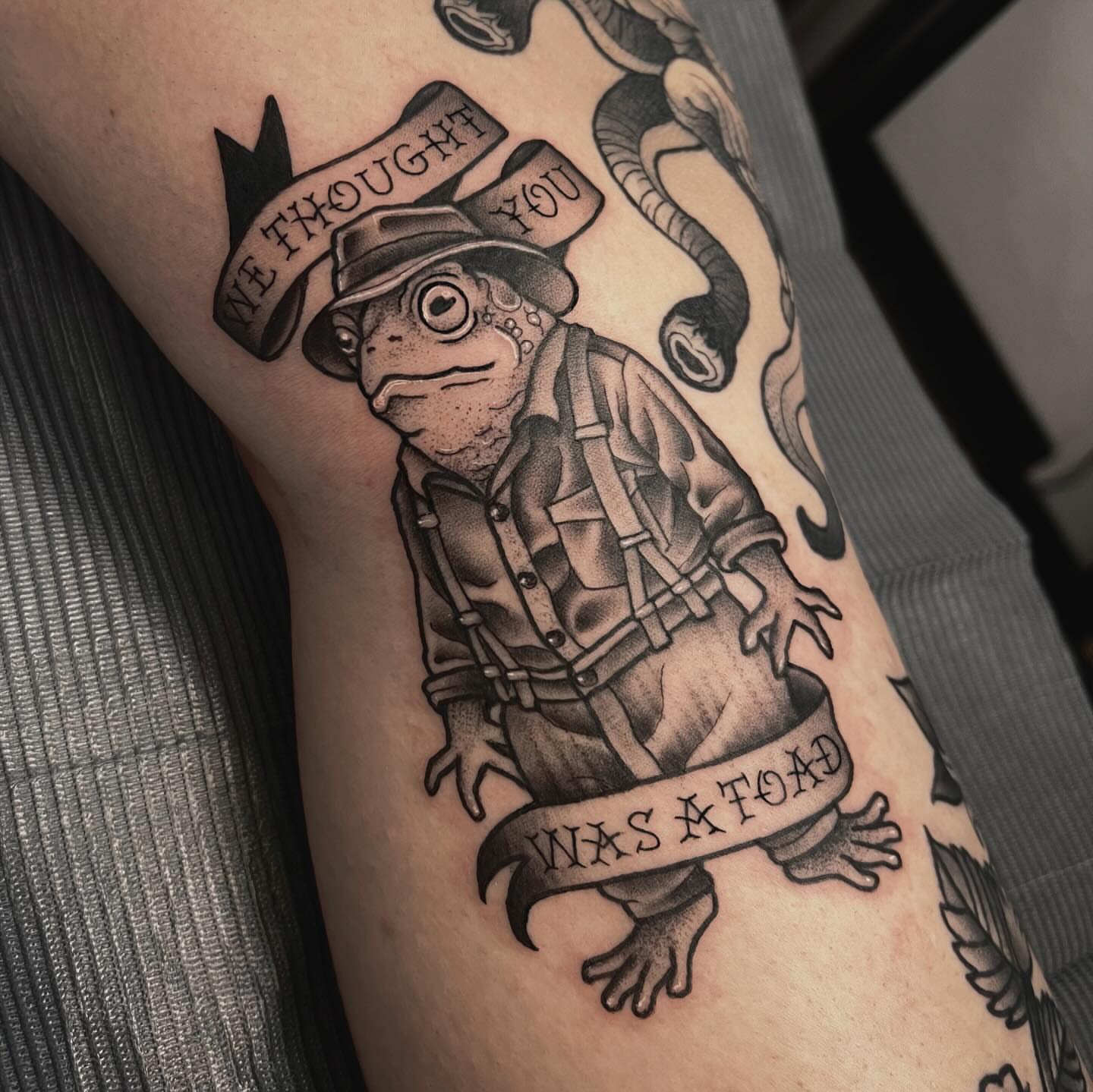 Frog in firefighter outfit American traditional tattoo on the forearm by Sarah Foltz