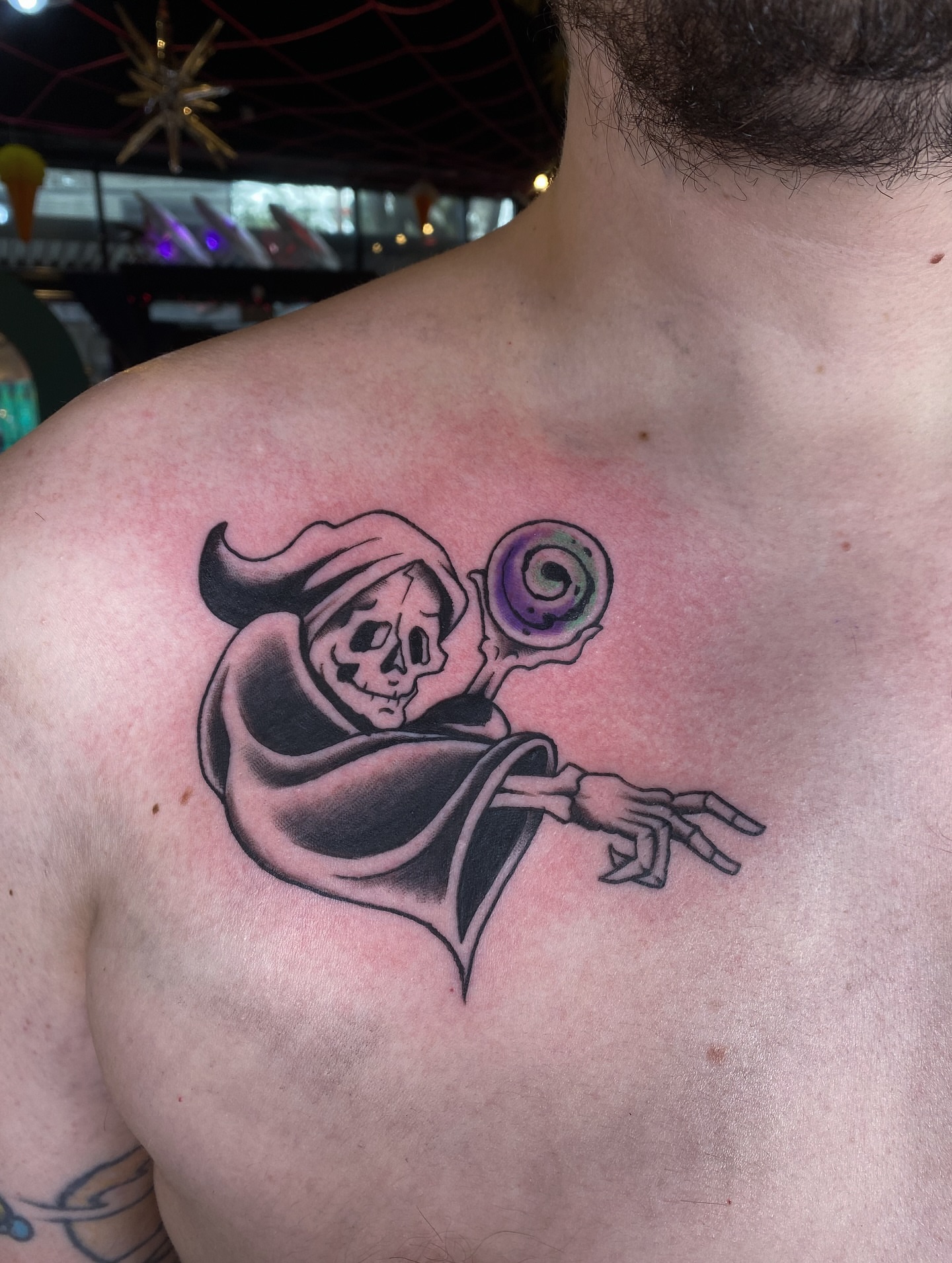 Skeleton with crystal ball black and grey tattoo on the chest by Karl Hegwein, Portland, Oregon