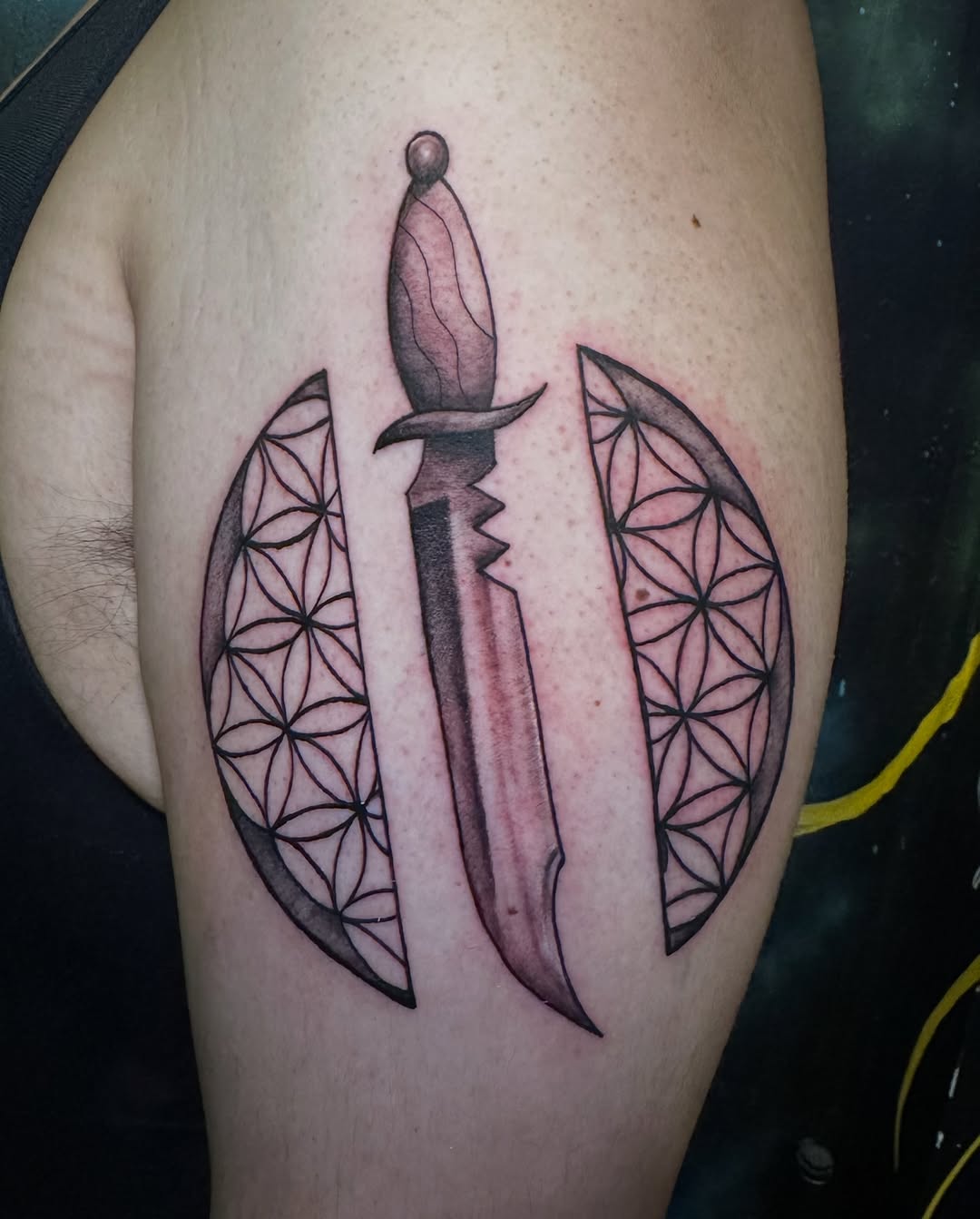 Dagger and flower of life geometric tattoo on the thigh by Alexander Haber