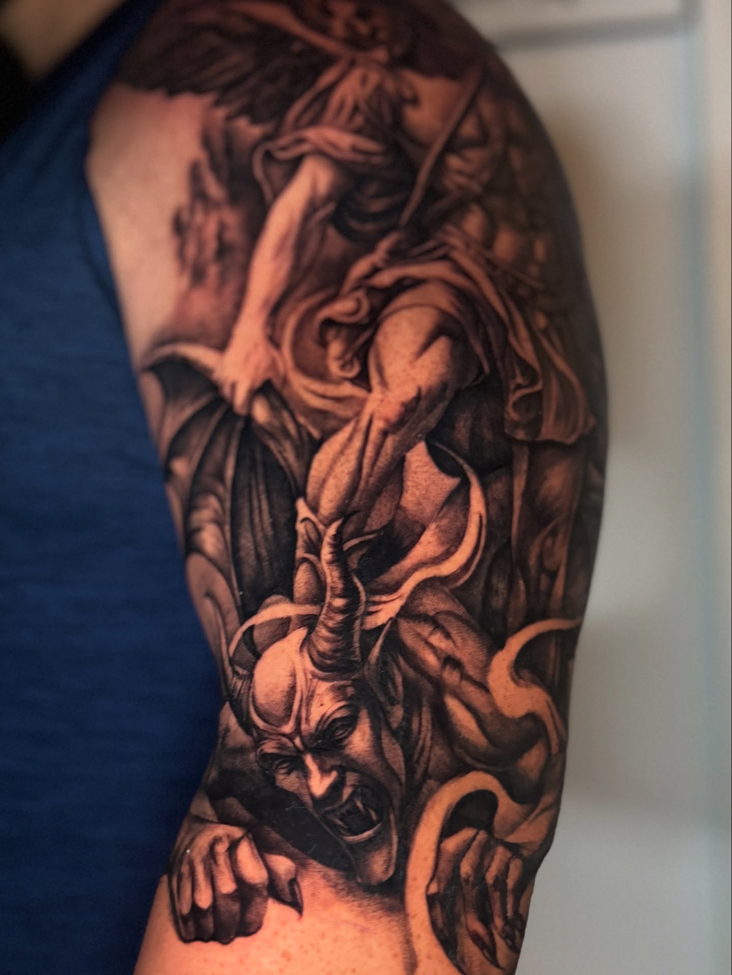 Demon dark realism tattoo on the forearm by tombstone