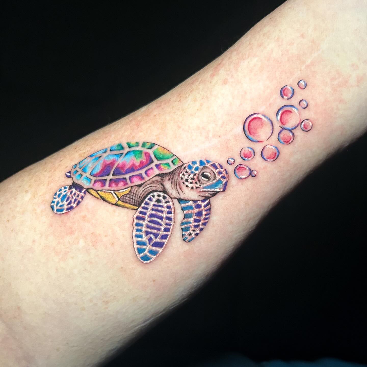 Sea turtle watercolor tattoo on the forearm by Maia Pizarro