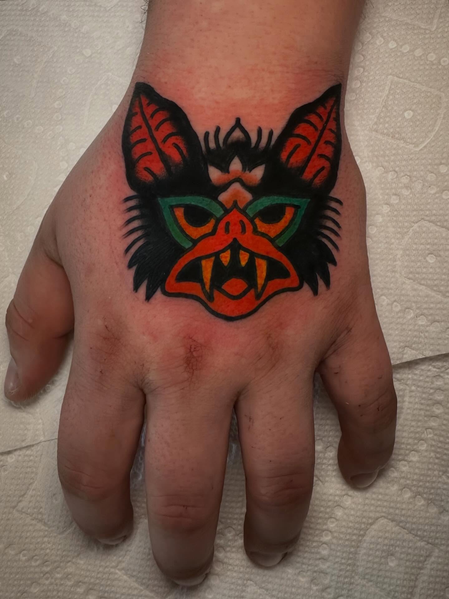 Bat mask American traditional tattoo on the hand by Isaac Brethauer