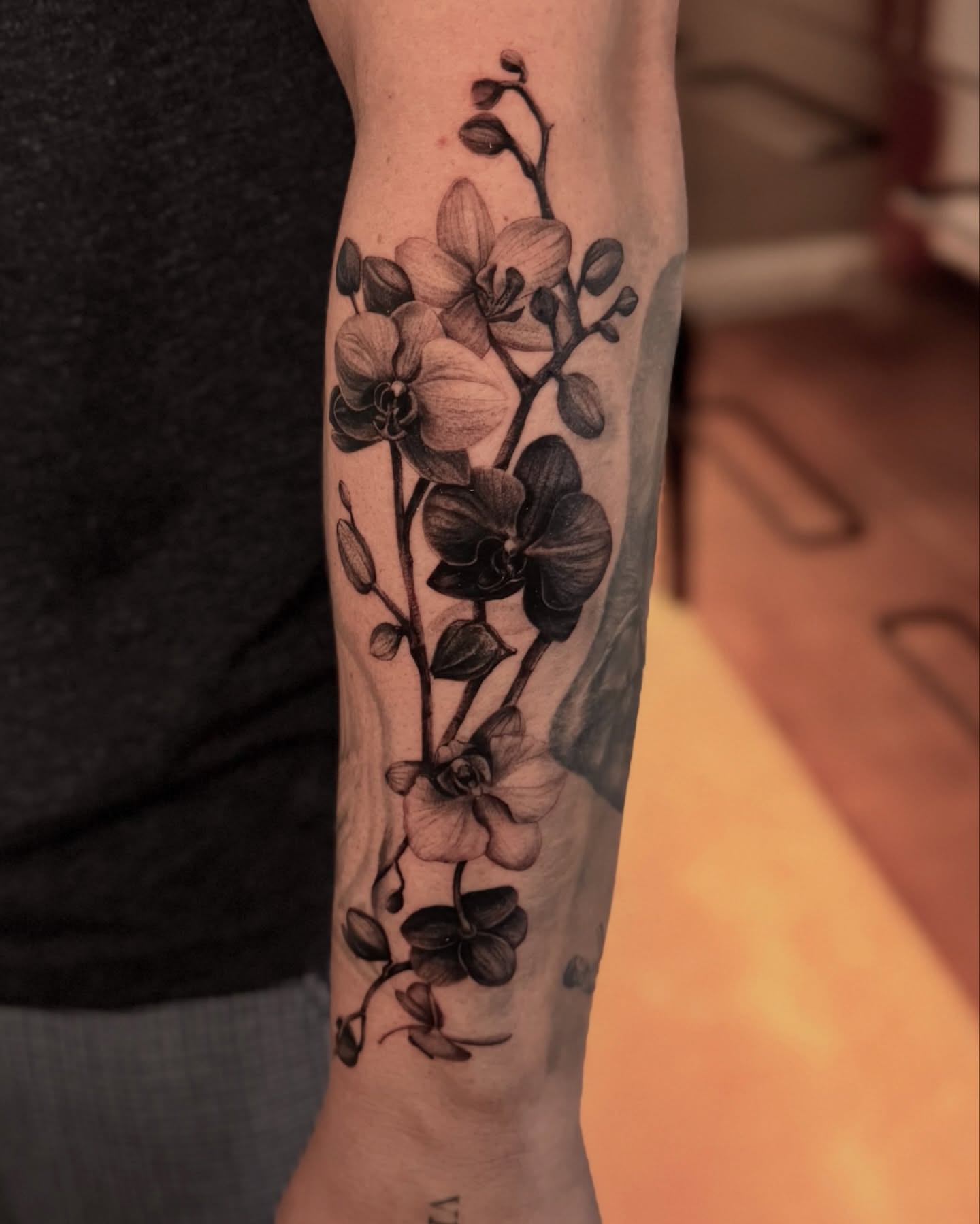 Orchids black and grey tattoo on the forearm by Ninna