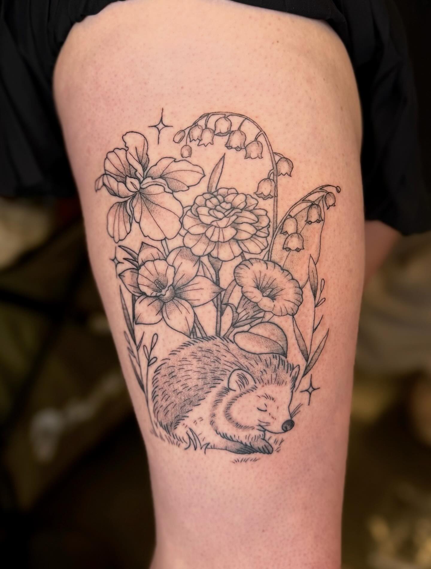 Sleeping hedgehog with flowers realism tattoo on the thigh by Brandi 🕷, Mentor, Ohio