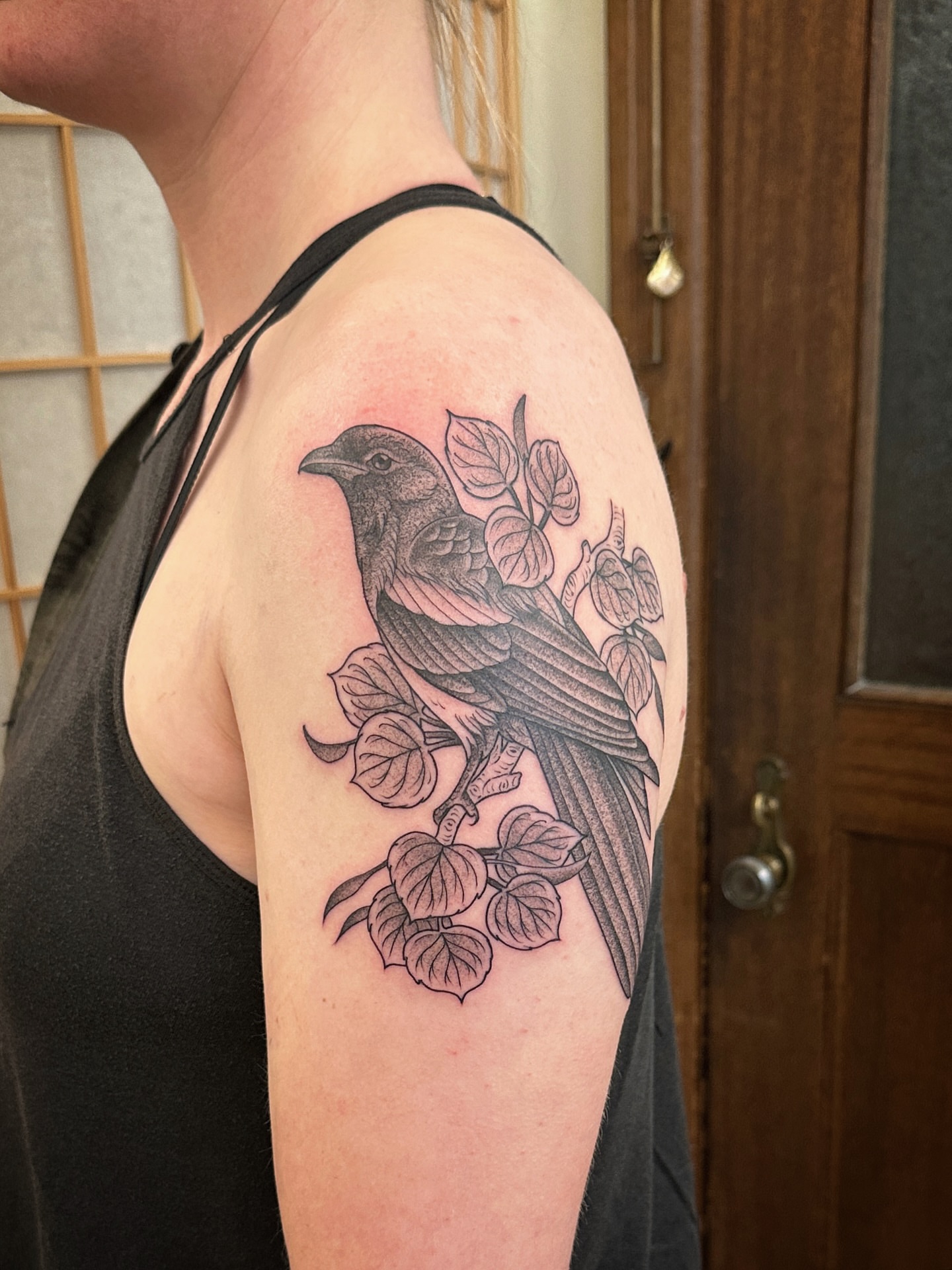 Bird and leaves black and grey tattoo on the shoulder by Tattooing by Patty Valentine