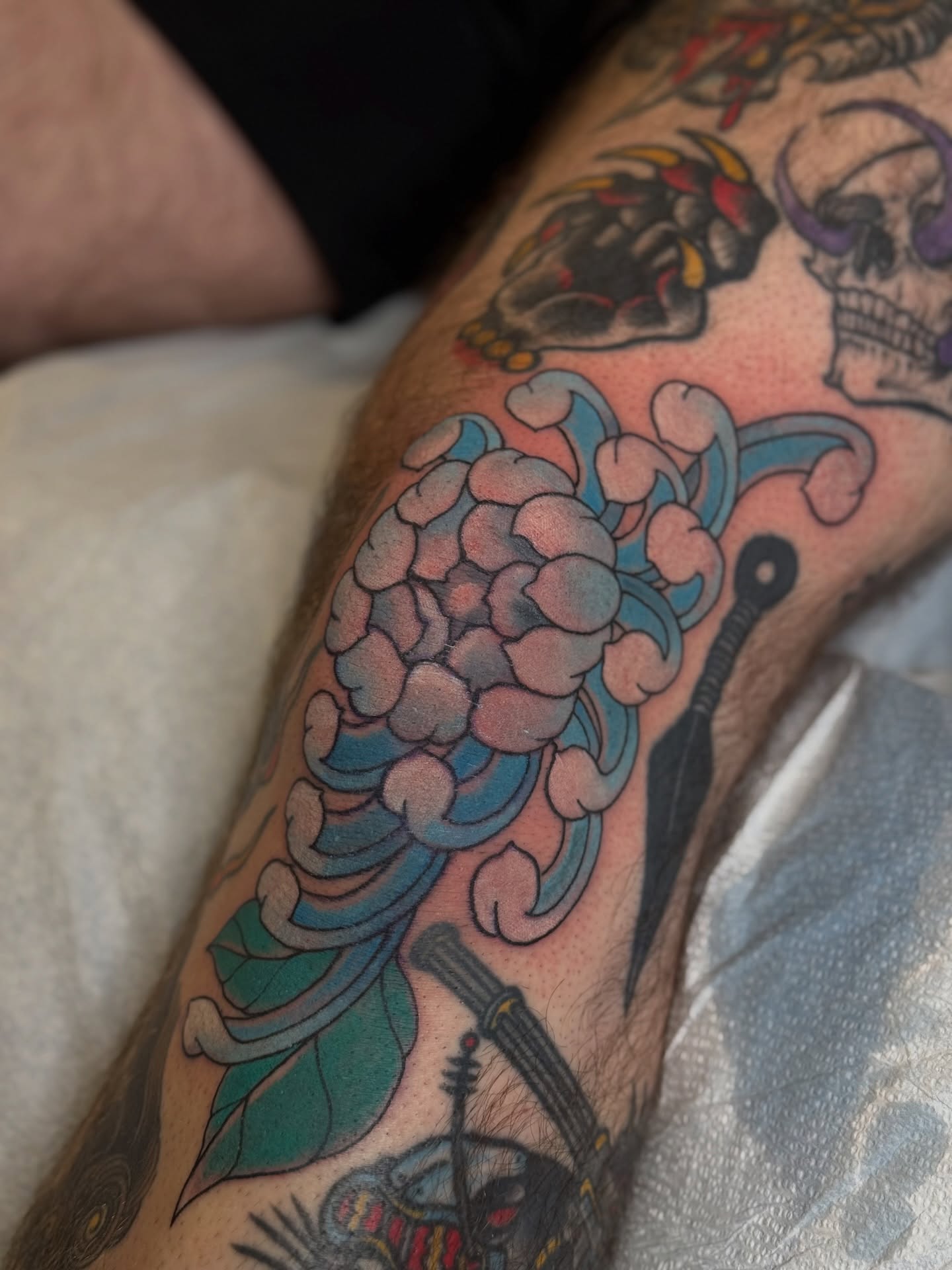 Chrysanthemum American traditional tattoo on the forearm by B e A U B R A D y, Costa Mesa, California