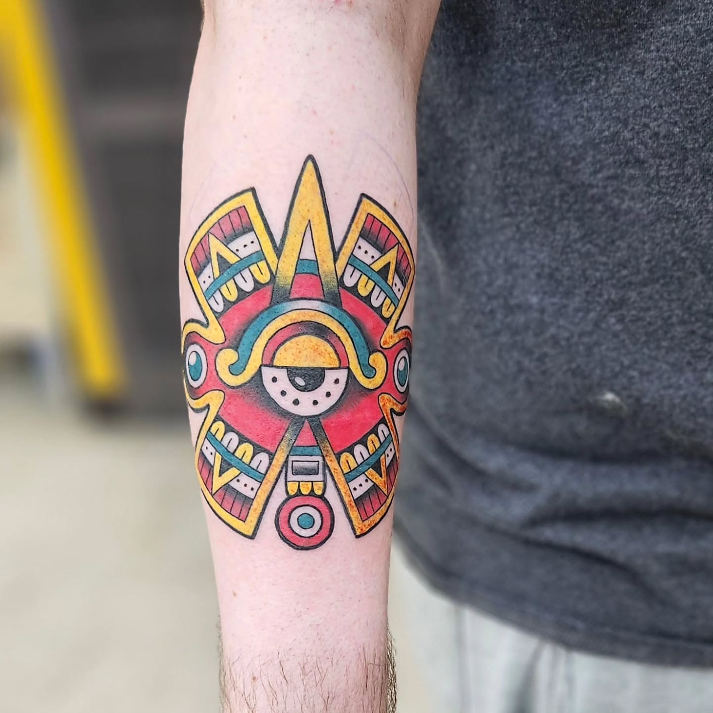 Mask geometric tattoo on the forearm by Jordanna Pearl