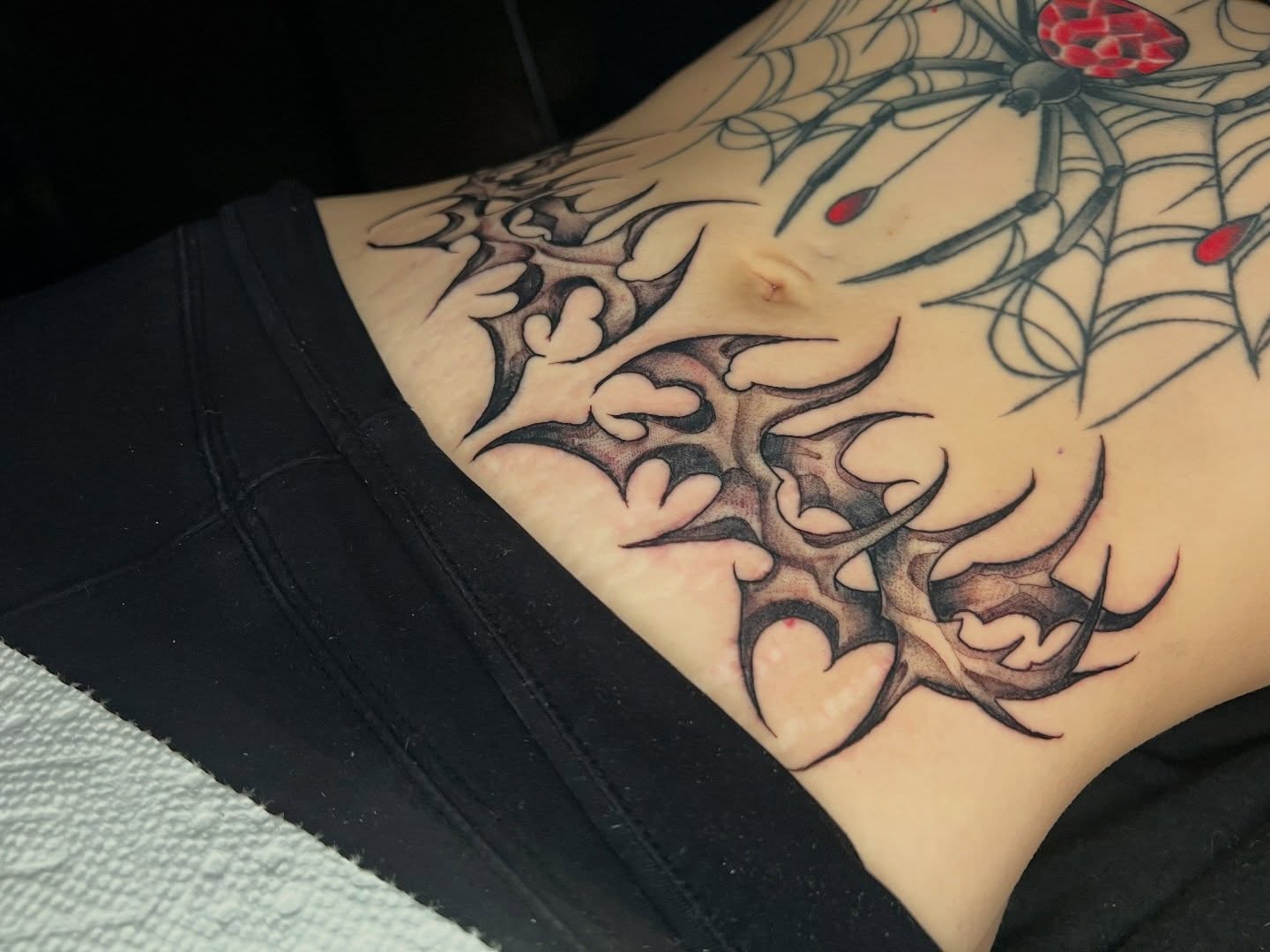 Spider web tribal tattoo on the torso by Brandon Durbin