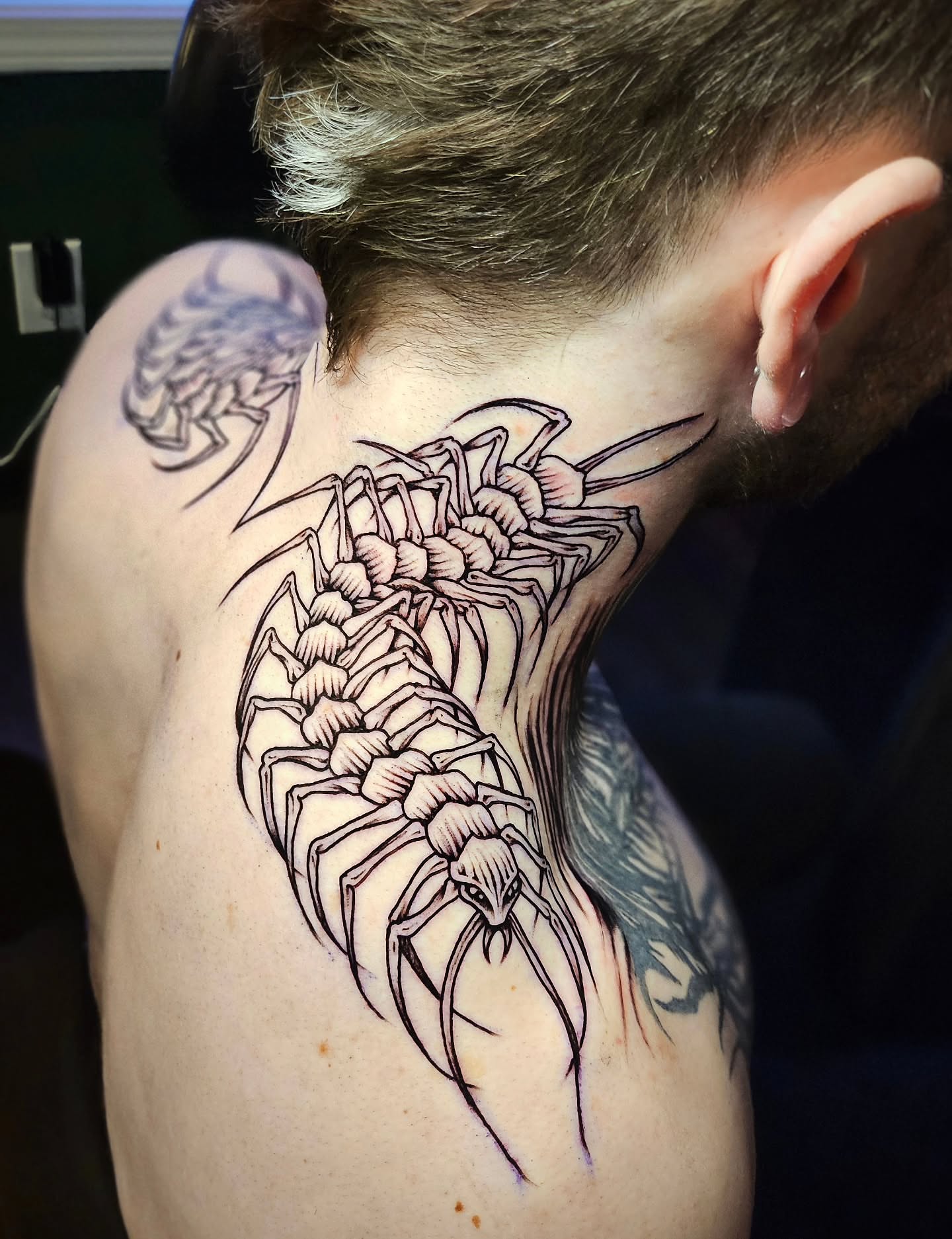 Centipede black and grey tattoo on the shoulder by Monaca Patterson