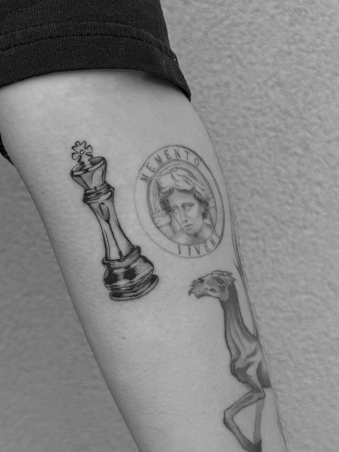 Chess king and skeletal animal tattoo on the forearm by Abby Robinson