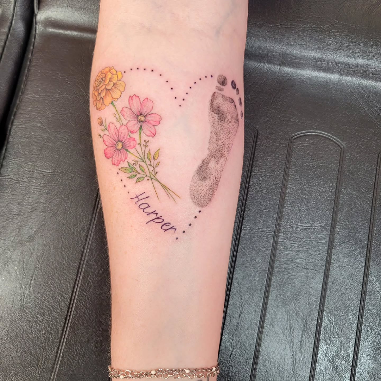 Footprint and flowers dotwork tattoo on the forearm by Mary Lefeau