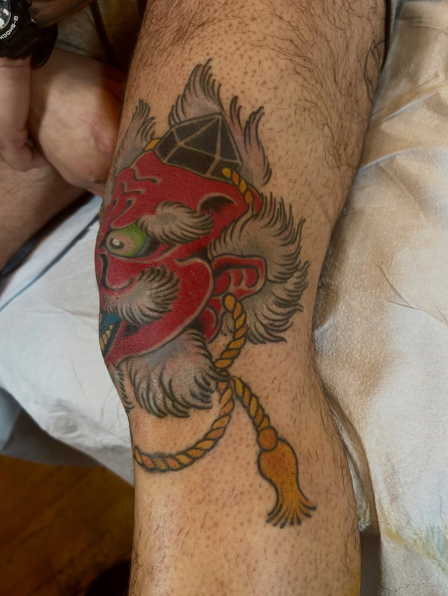 Japanese mask American traditional tattoo on the forearm by Justin Weatherholtz, New York, New York