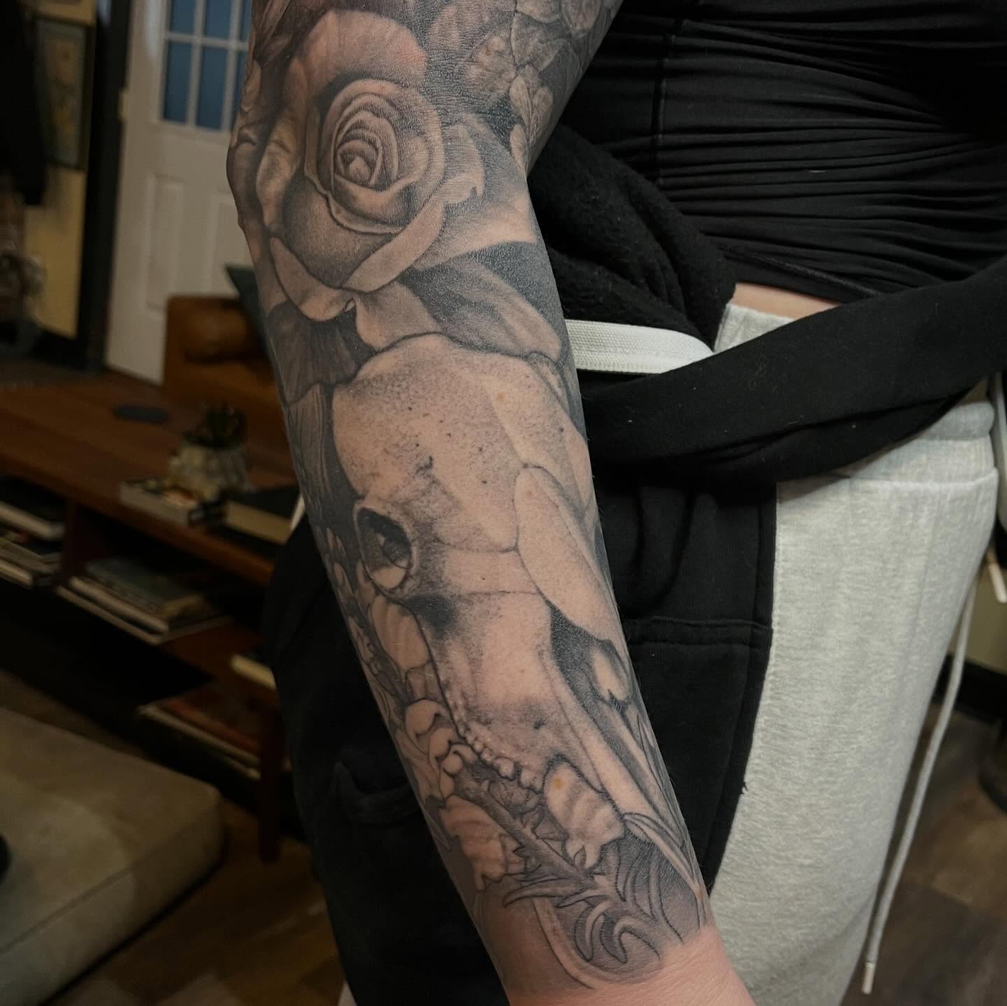 Skull and rose realism tattoo on the forearm by Adam Habecker