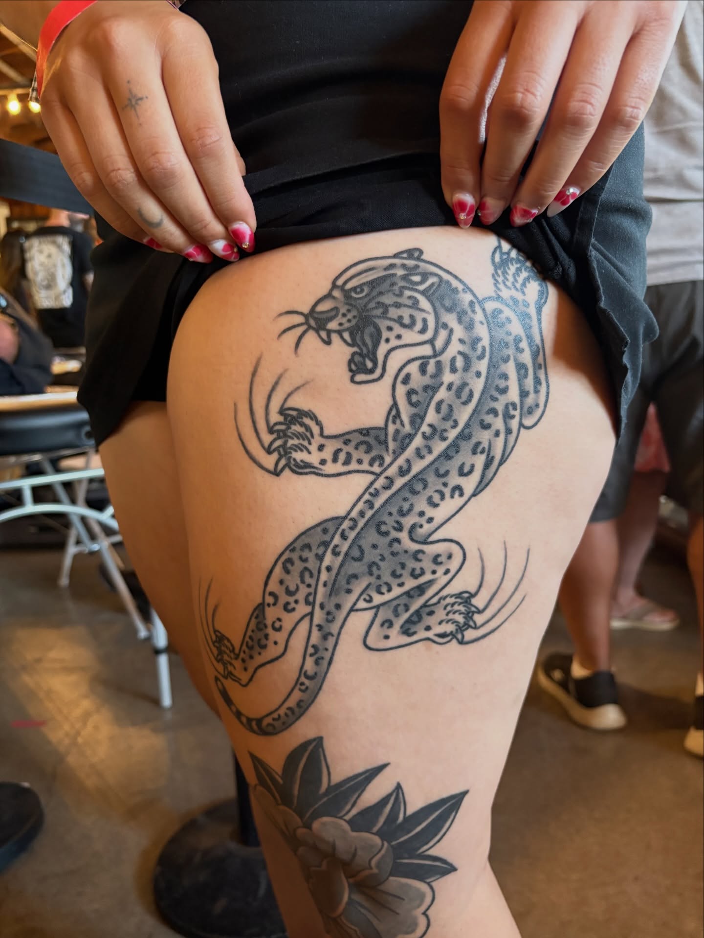 Leopard and flower black and grey tattoo on the thigh by Dallas Tattoo Artist