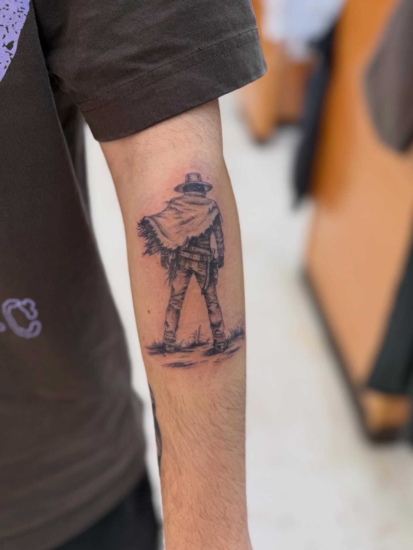 Cowboy walking realism tattoo on the forearm by Levi Sawdon, Everett, Washington
