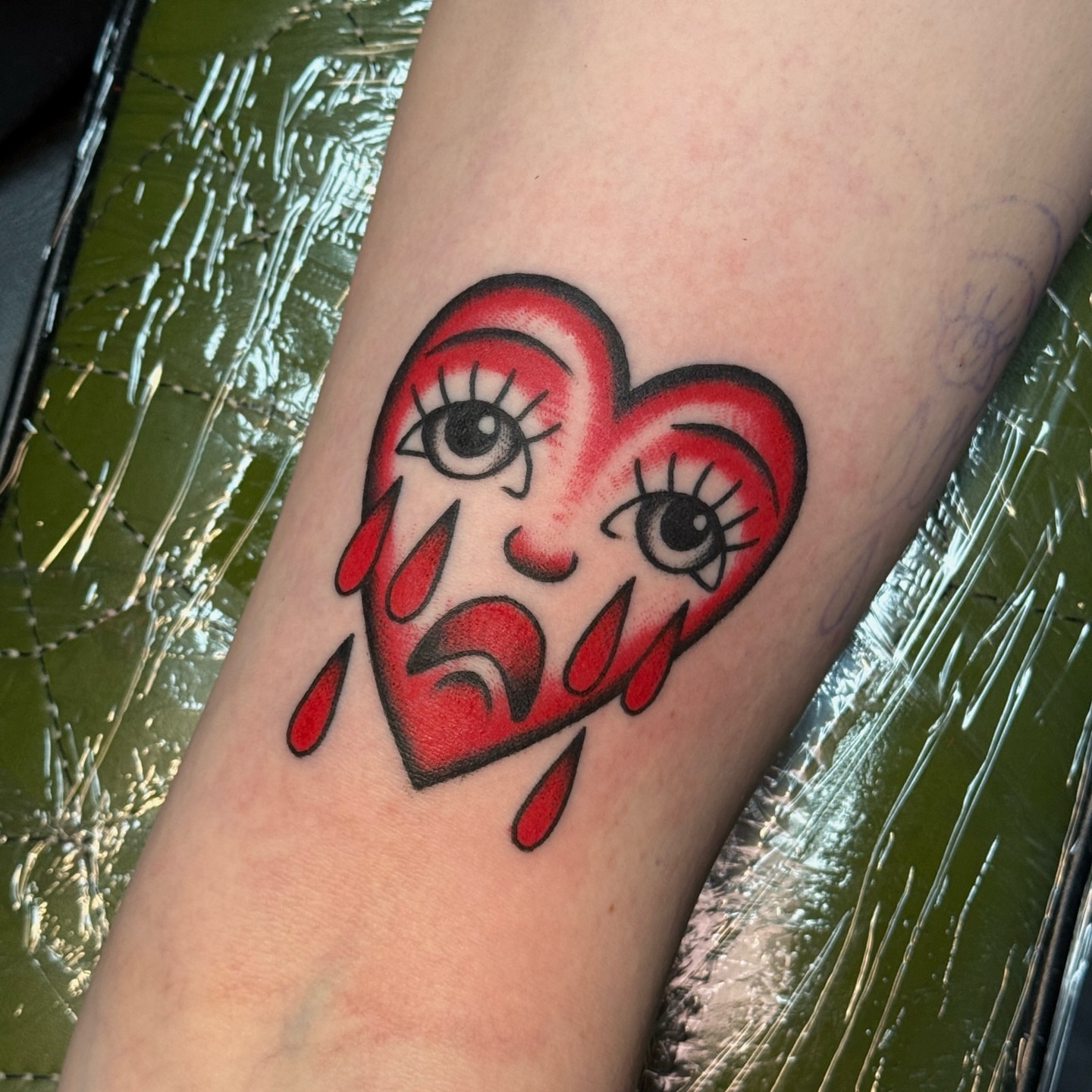 Crying heart American traditional tattoo on the forearm by Traddy Maddie ๐