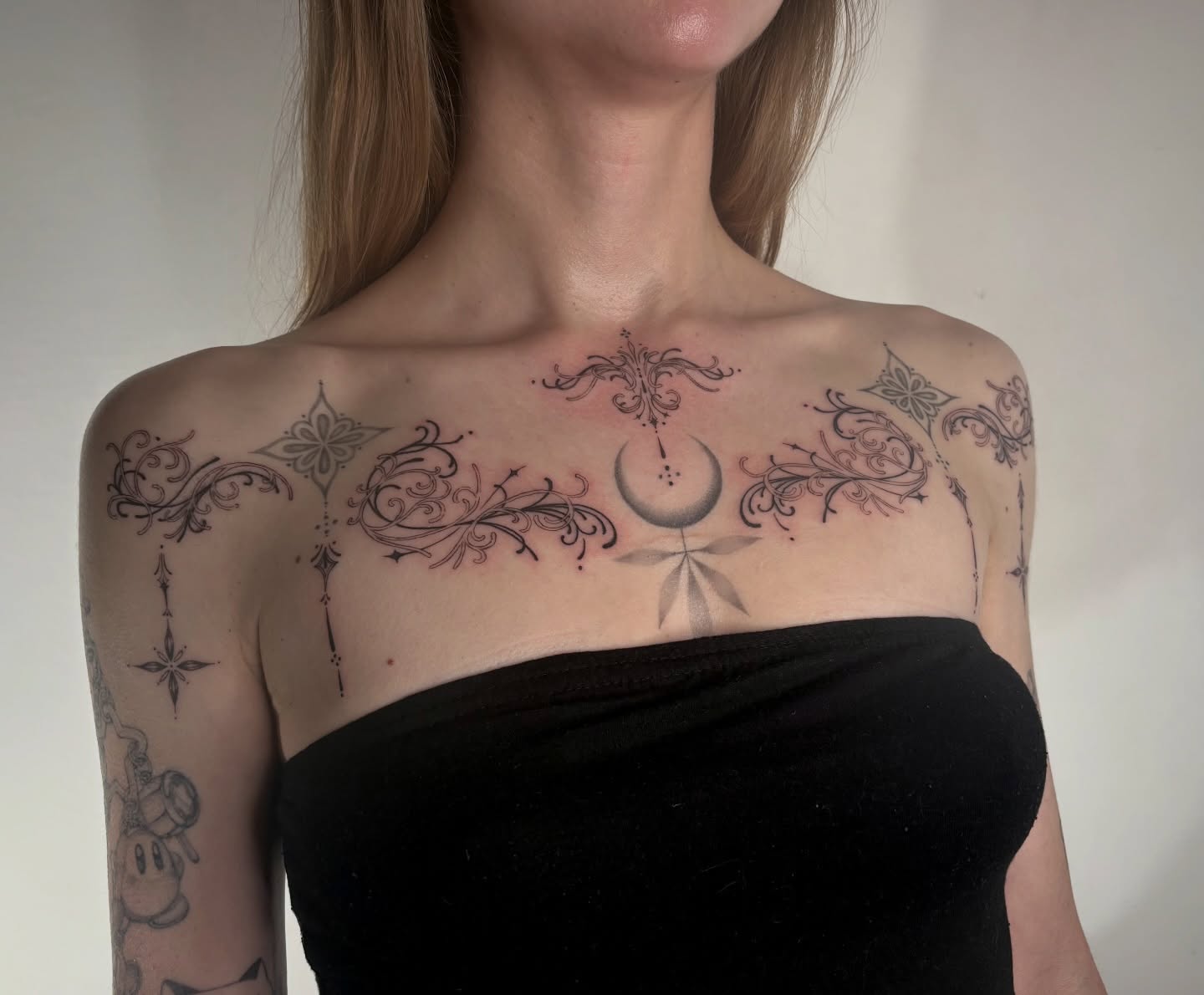 Moon and floral ornamental tattoo on the chest by @tattotos