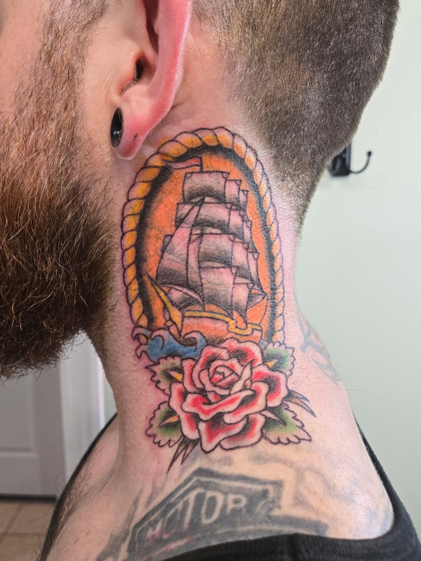 Ship and rose American traditional tattoo on the neck by Matt Page