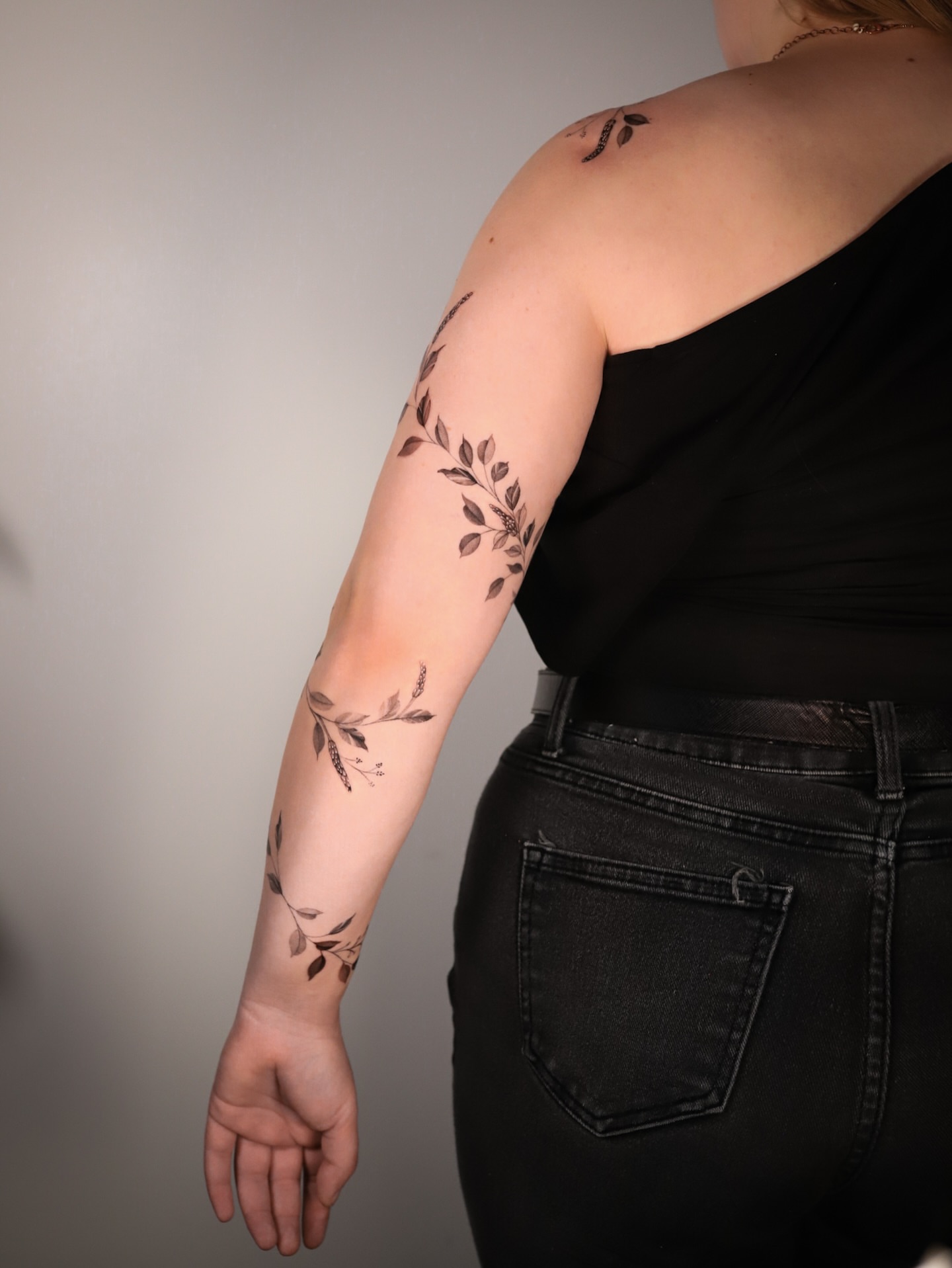 Branch with leaves black and grey tattoo on the forearm by Cyn