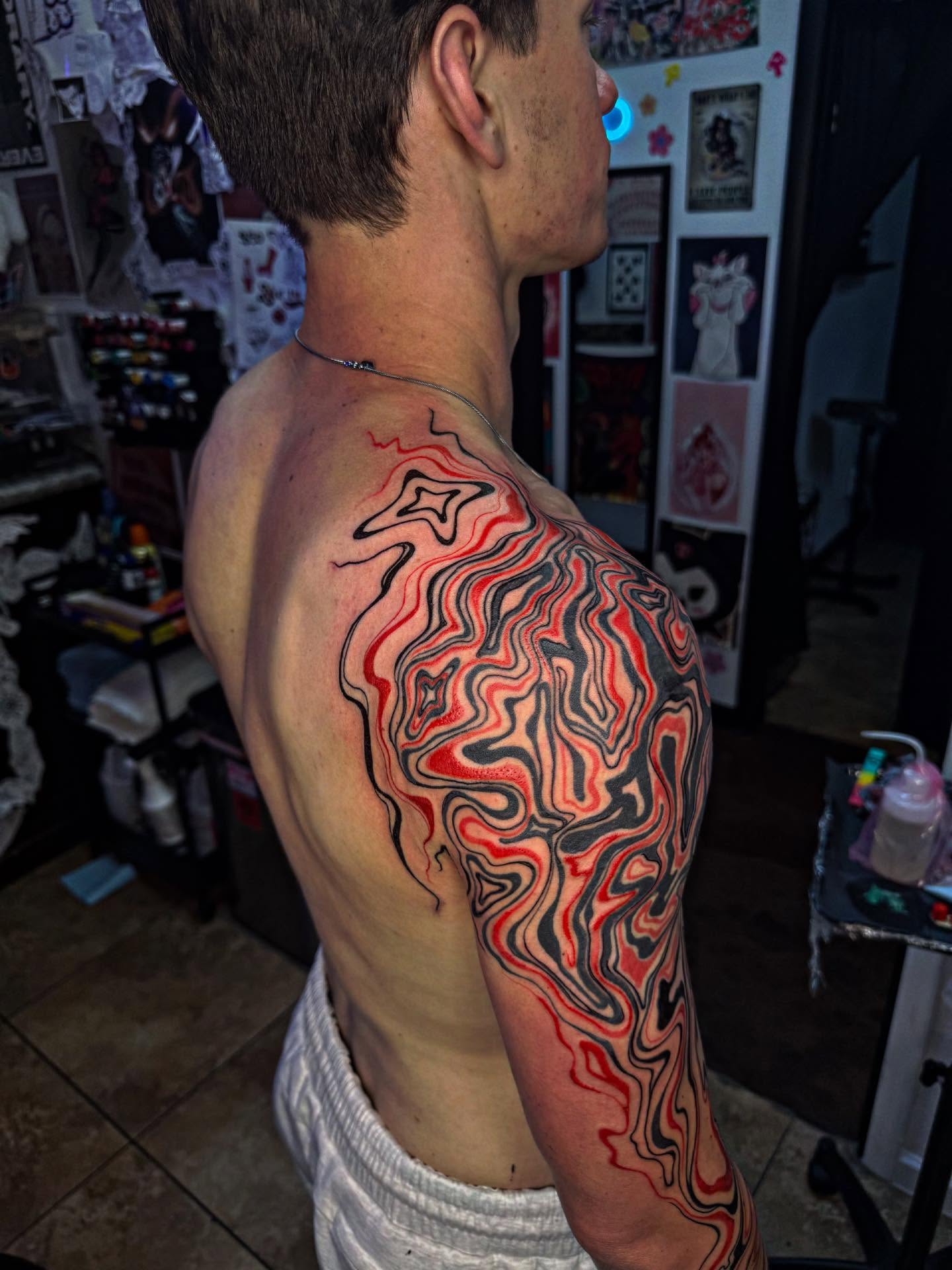 Abstract fluid pattern geometric tattoo on the shoulder by McKenna Hughes