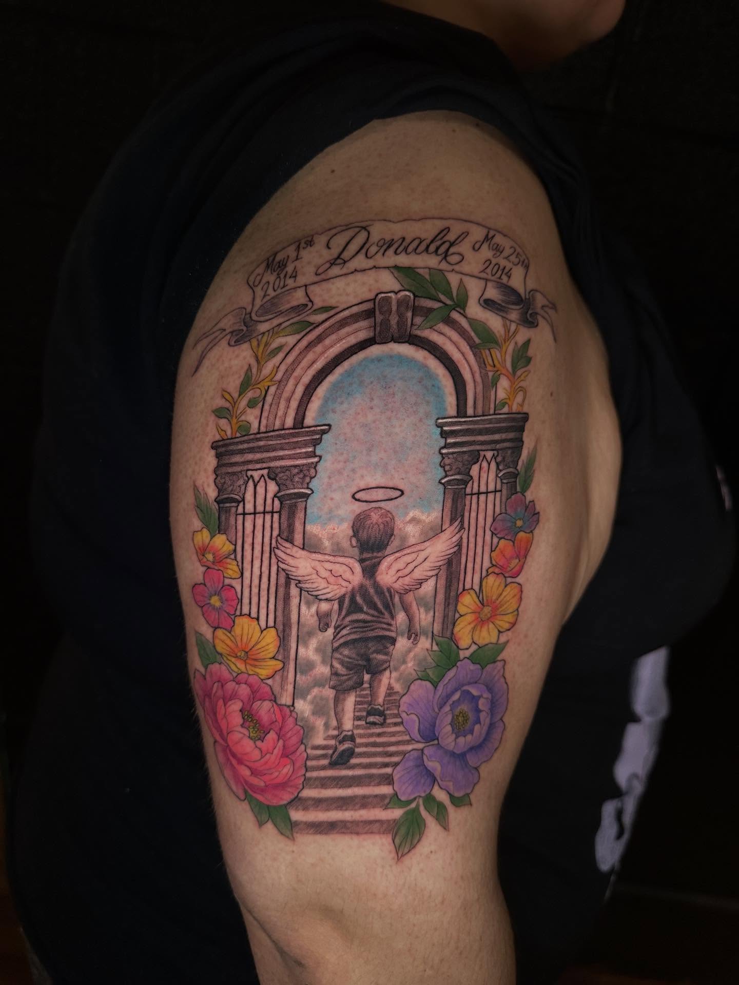 Angelic child ascending realism tattoo on the shoulder by Mario Flores Tattoo