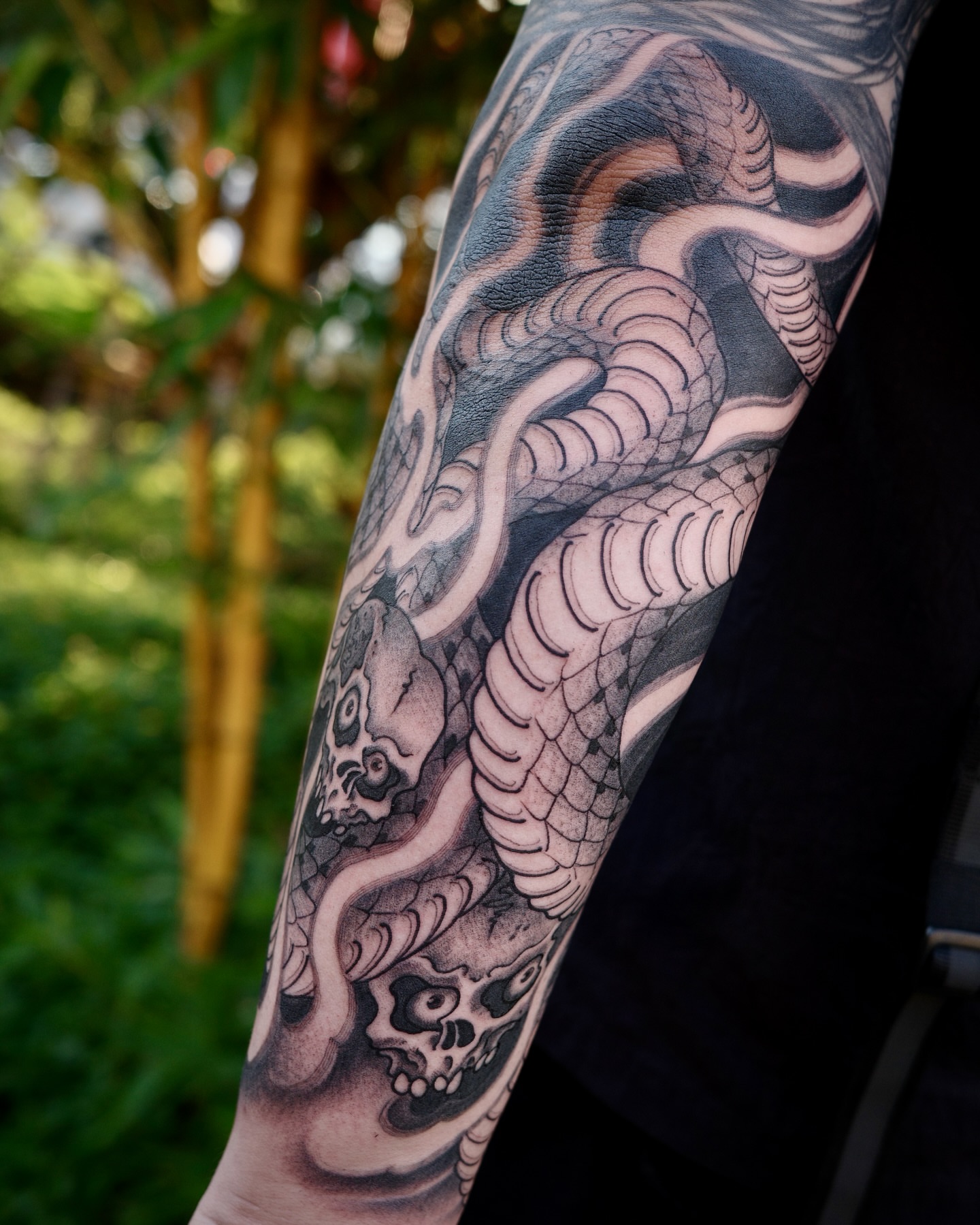 Snake and skull realism tattoo on the forearm by Scienz 九卦刺青