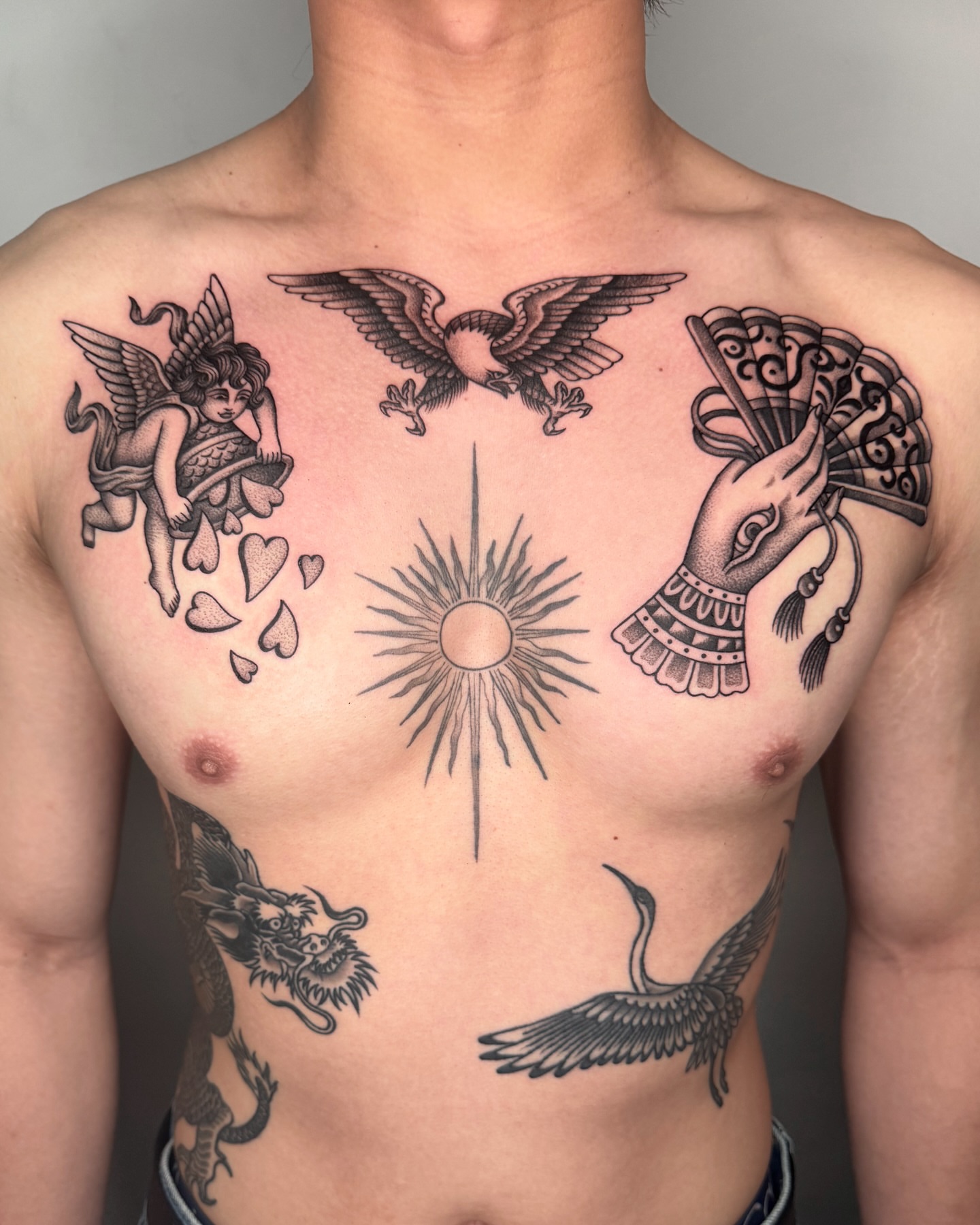 Mythical creatures and celestial elements American traditional tattoo on the chest by Jae Traditional Tattoo