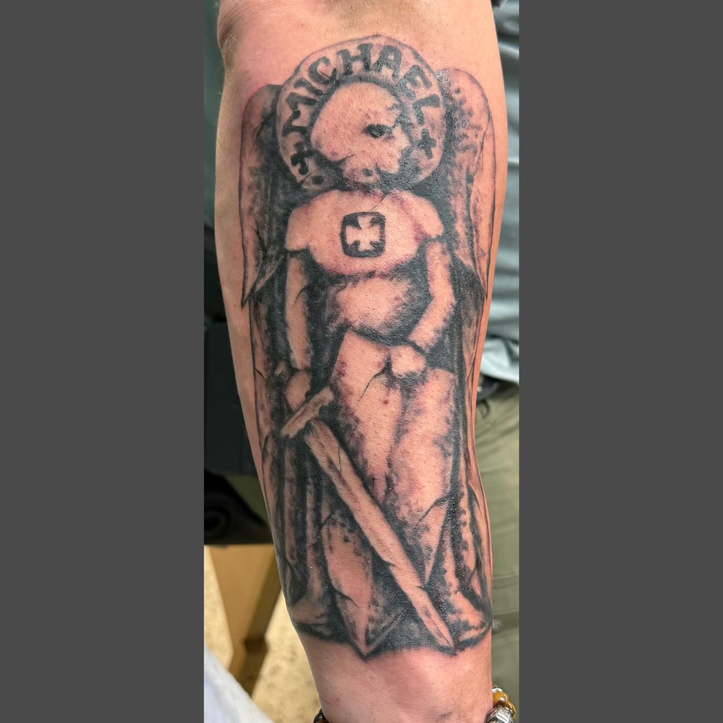 Angel with cross black and grey tattoo on the forearm by Richard Nagy, New Orleans, Louisiana