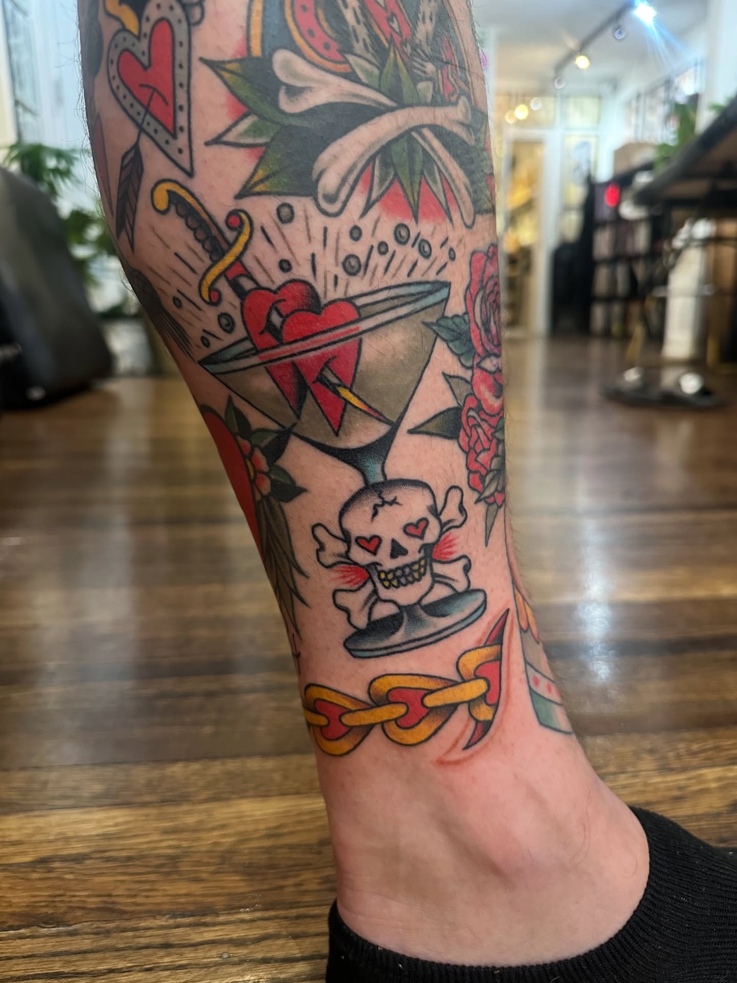 Heart and dagger American traditional tattoo on the calf by Stacy Fevinger