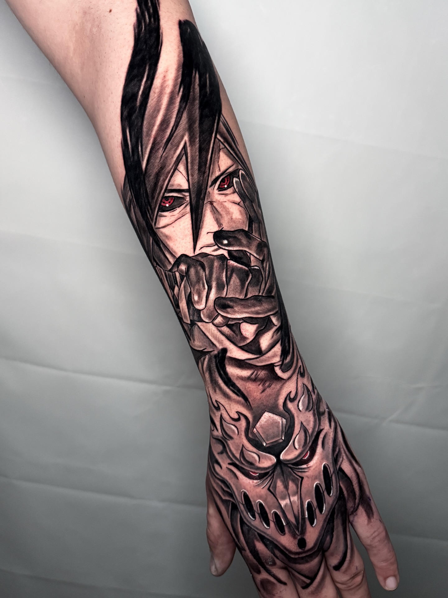 Anime character dark realism tattoo on the forearm by Christian Pelaez