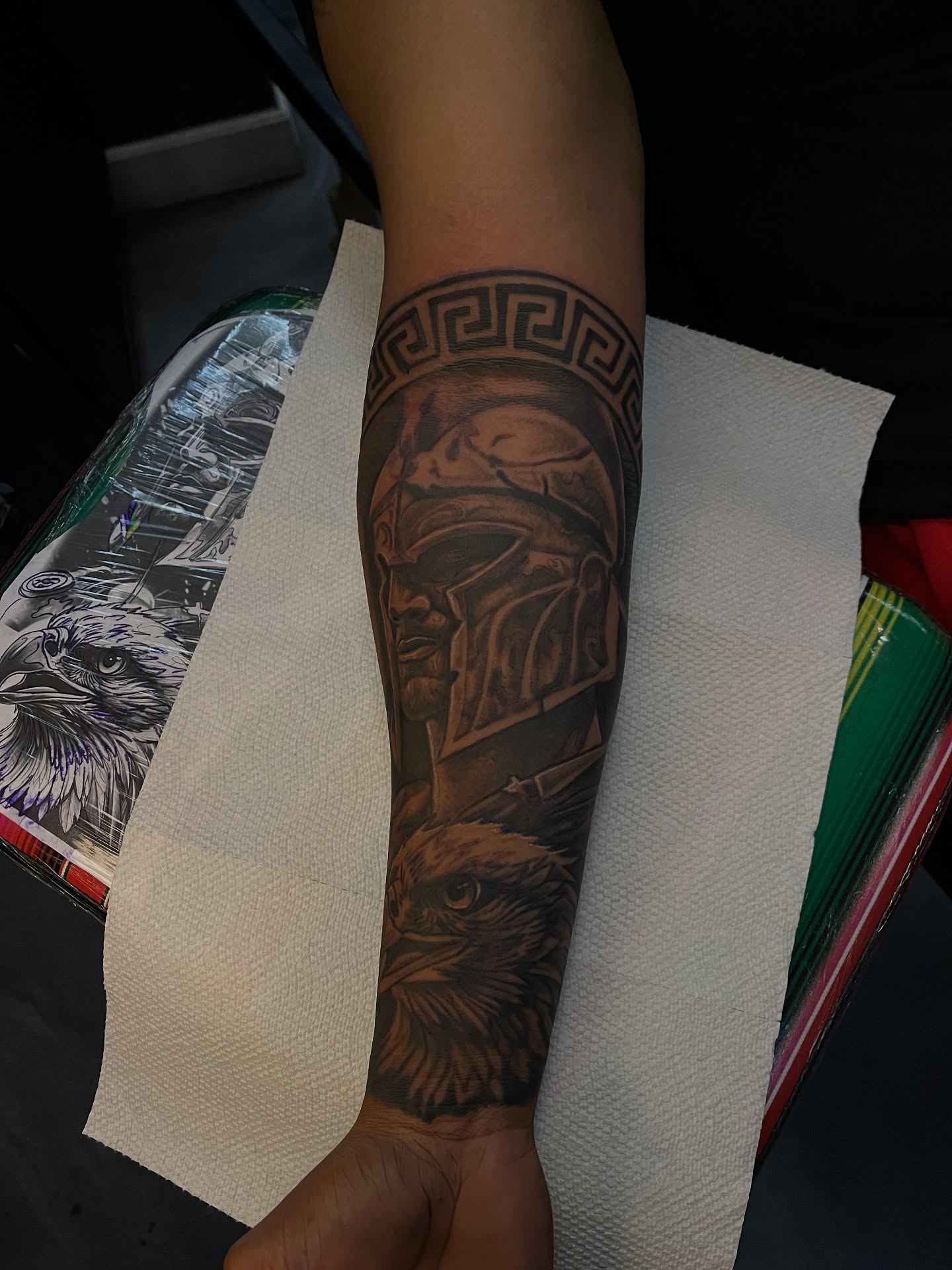 Warrior helmet and eagle realism tattoo on the forearm by Dee