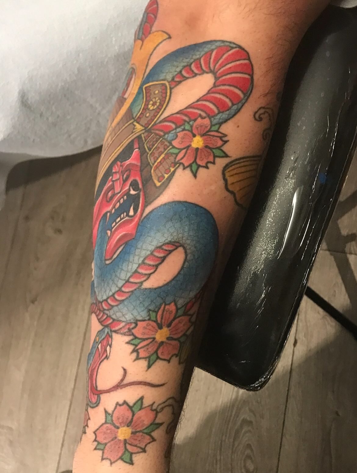 Snake and flowers American traditional tattoo on the forearm by Miles Maniaci, Chicago, Illinois