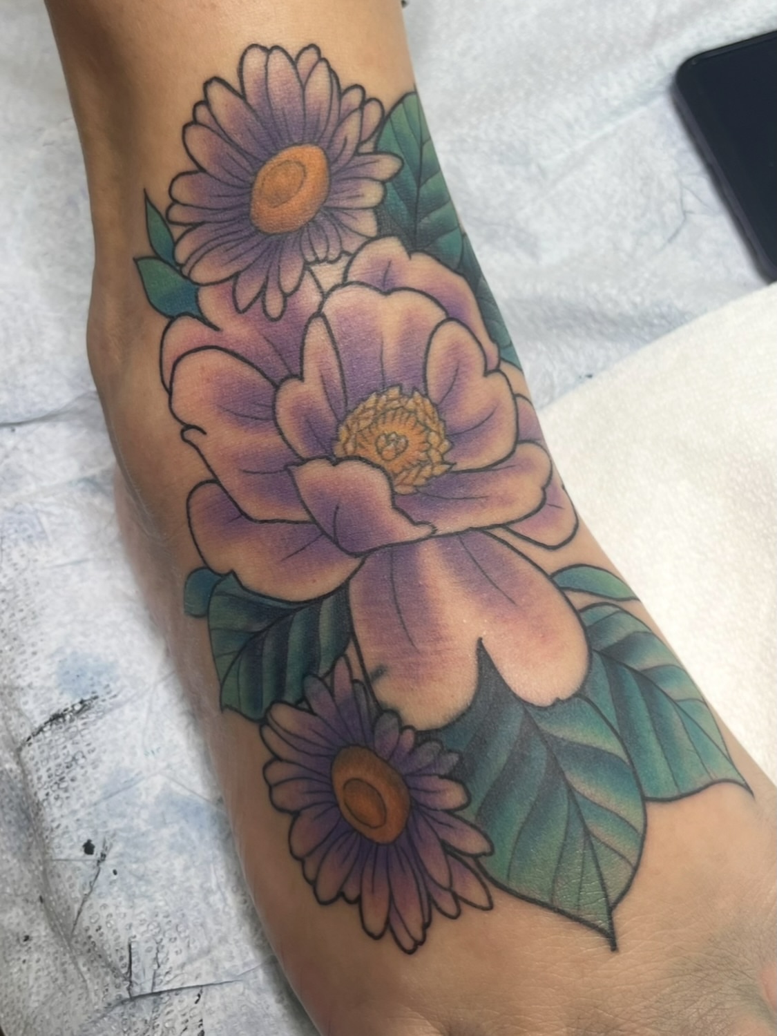 Flowers American traditional tattoo on the forearm by Evan Perrine