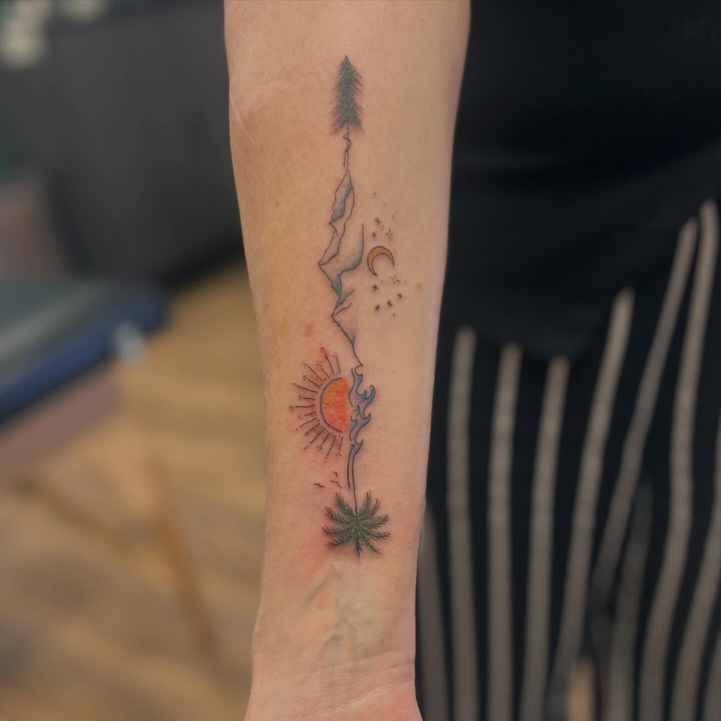 Tree and sun dotwork tattoo on the forearm by Victorian Coleman