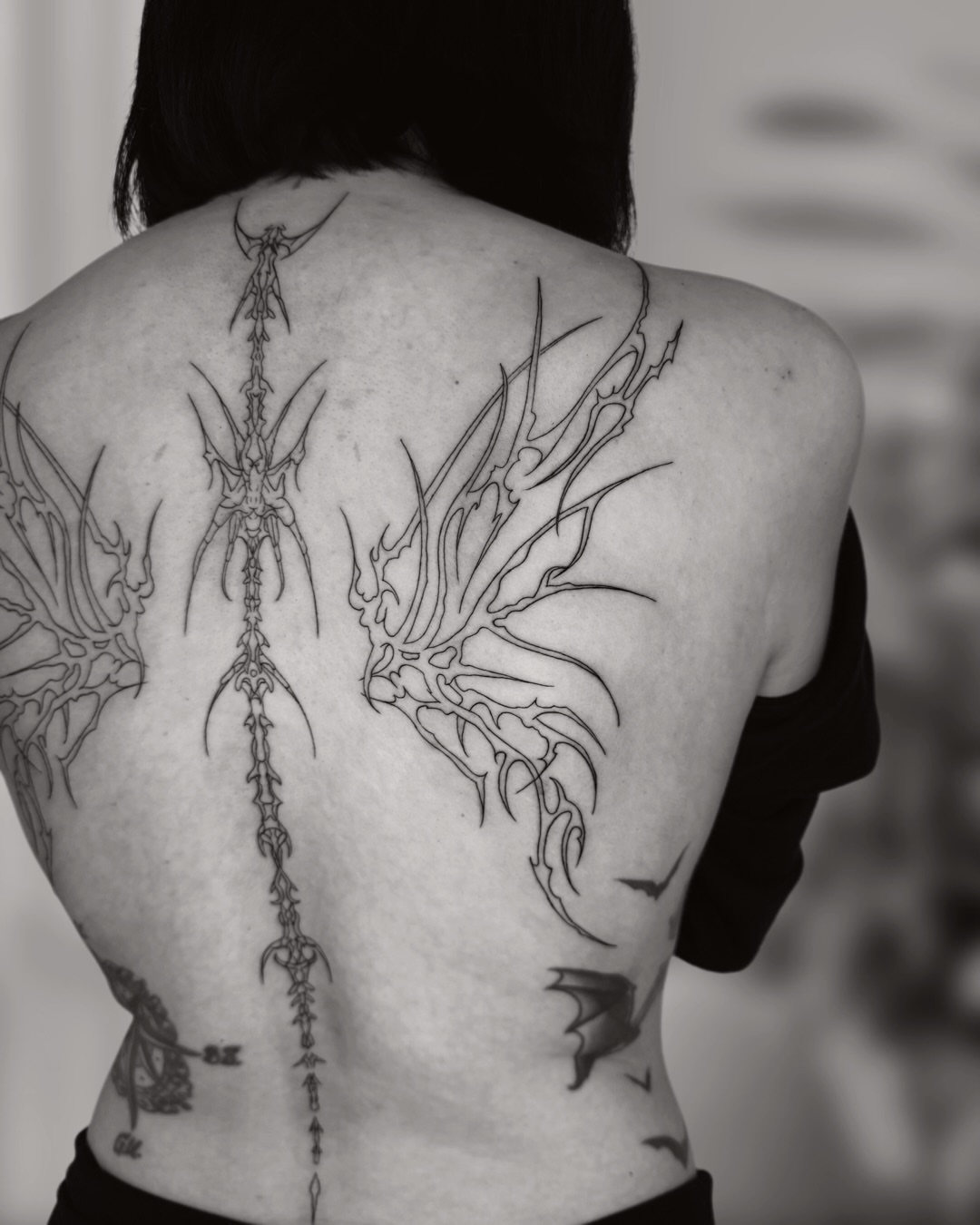 Winged dragon geometric tattoo on the back by Ingrid Rojas