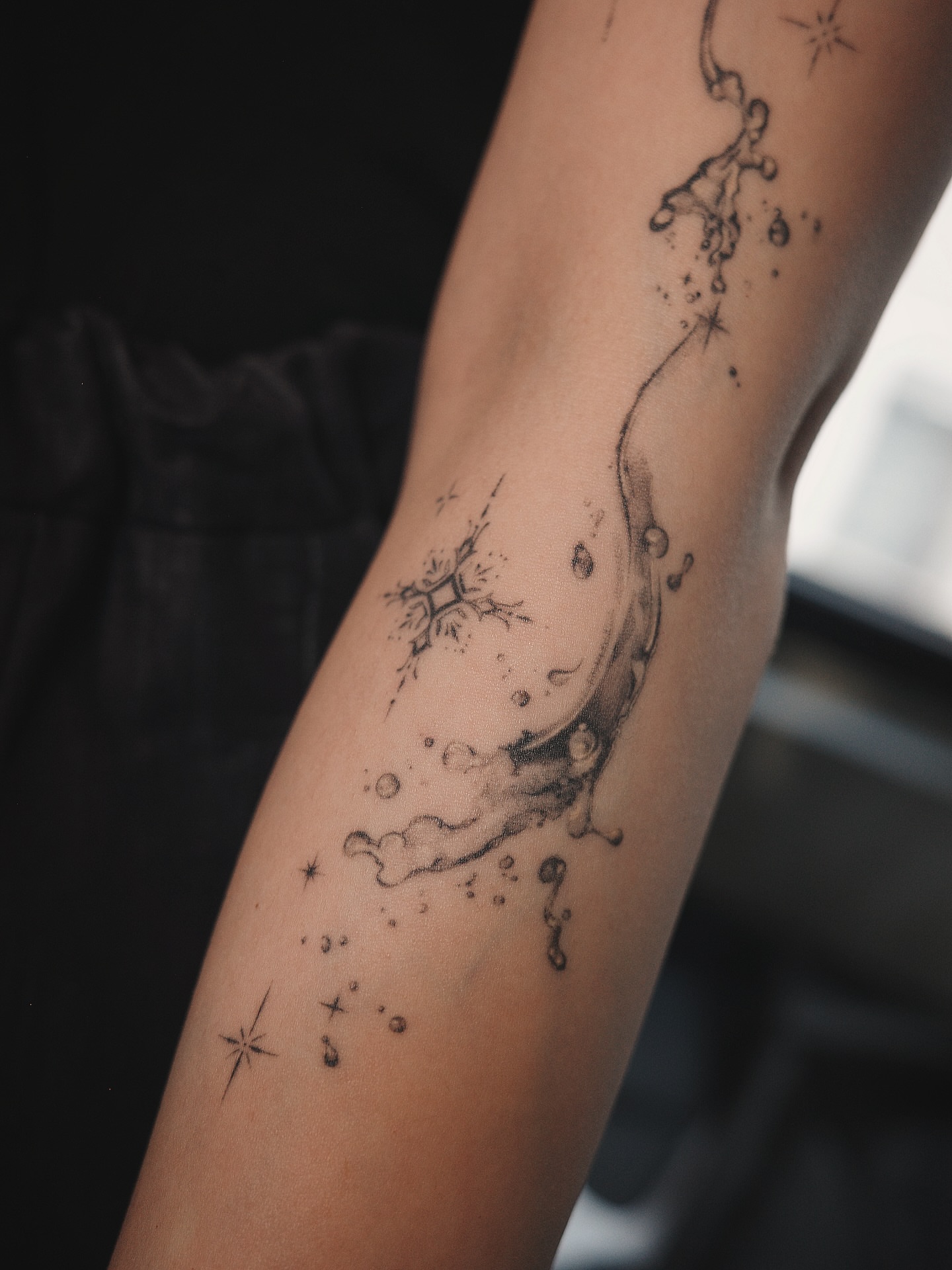 Water splash black and grey tattoo on the forearm by Easy