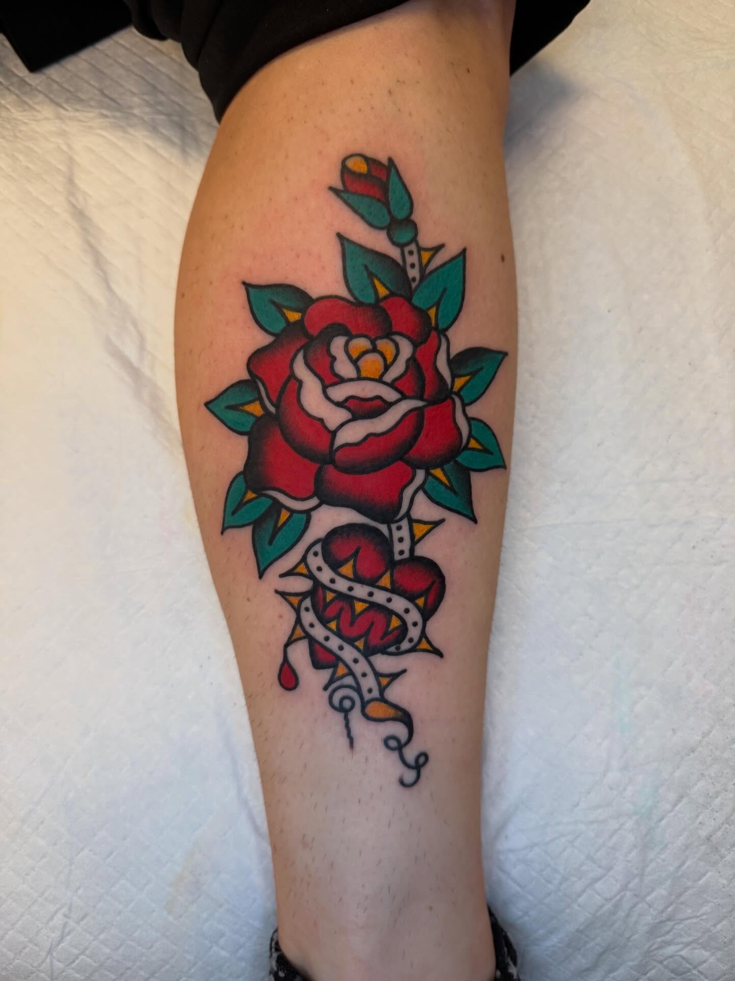 Rose American traditional tattoo on the thigh by Atom Aker