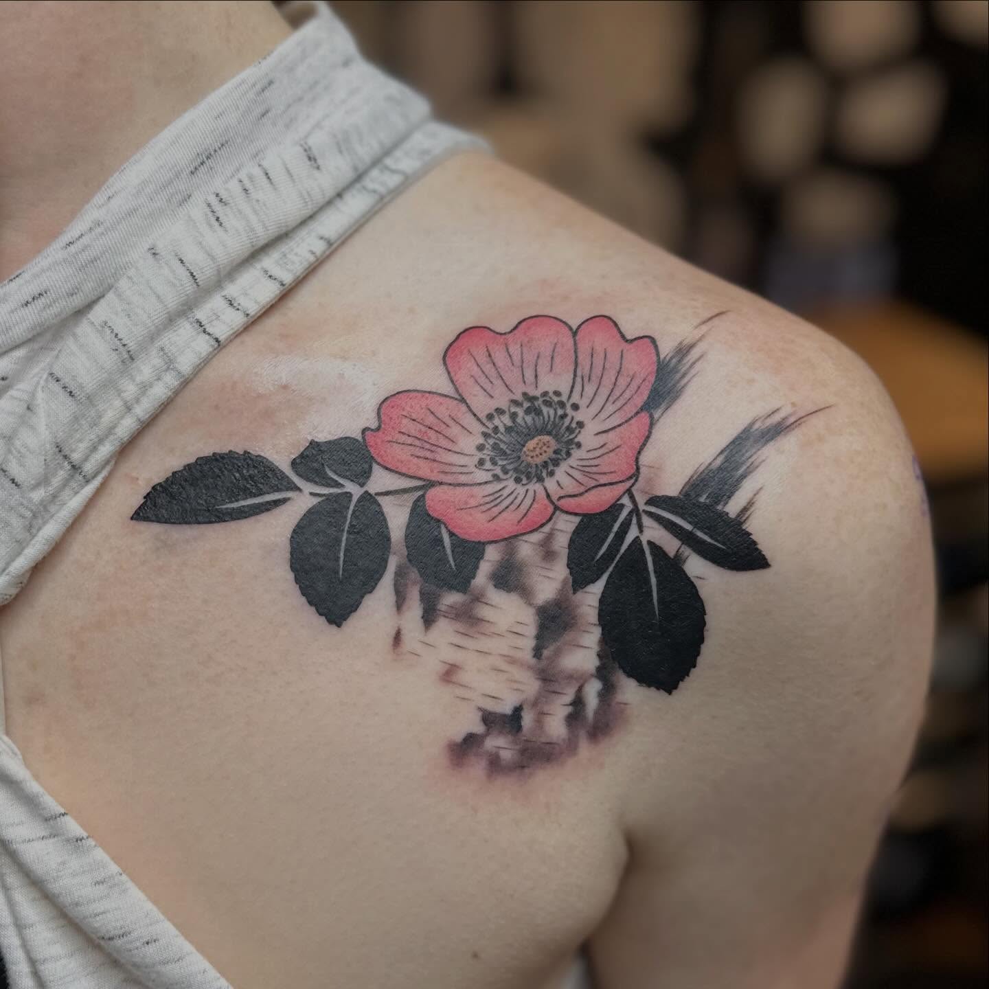 Flower and skull American traditional tattoo on the shoulder by Megan Sierra