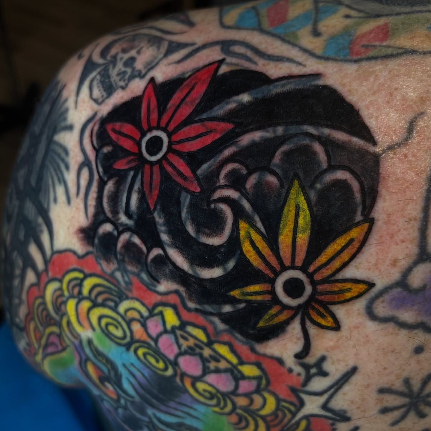 Flower and wave American traditional tattoo on the shoulder by Santo Zelaya, San Francisco, California