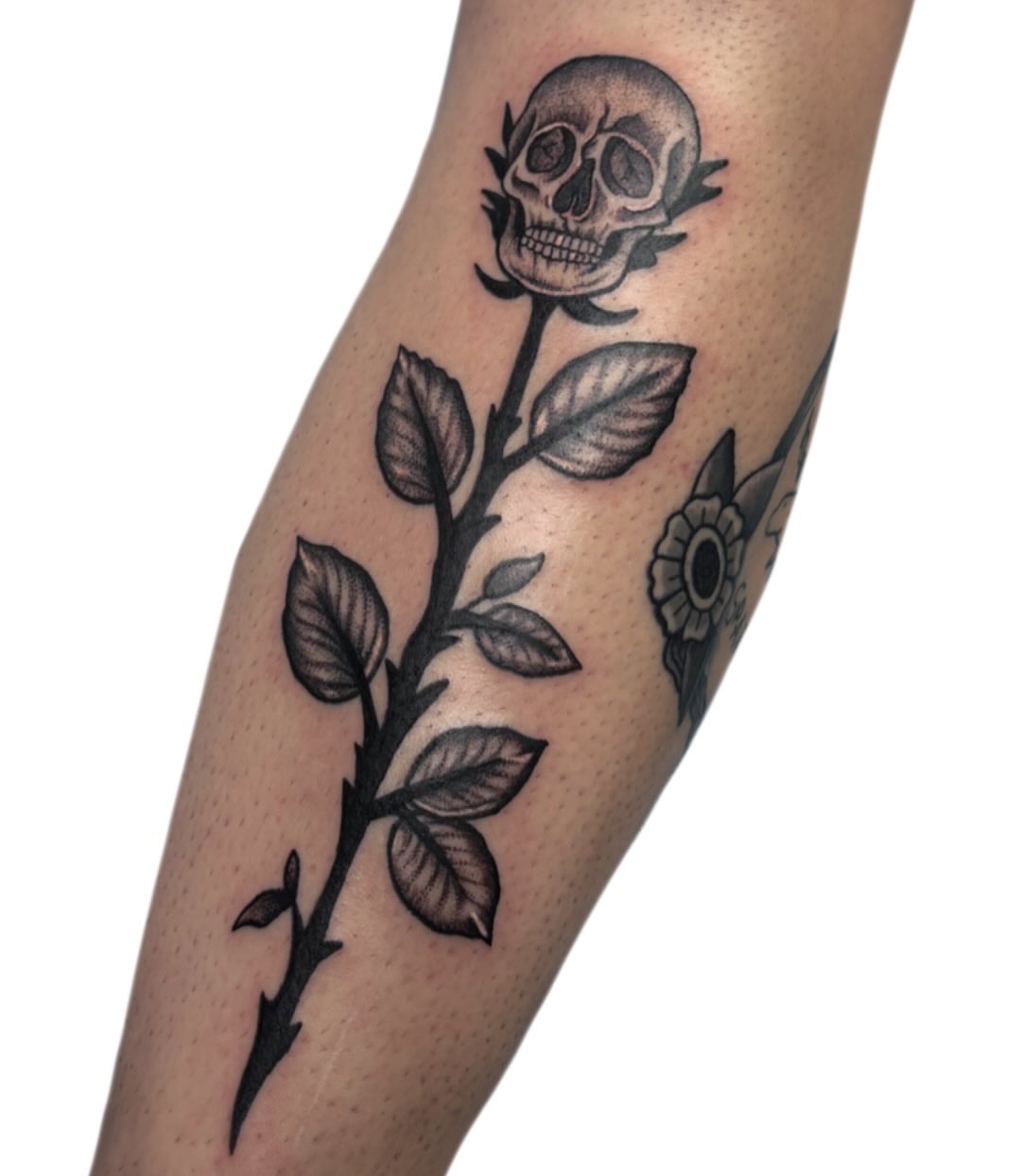 Skull and rose black and grey tattoo on the forearm by Ava Brady Tattoos