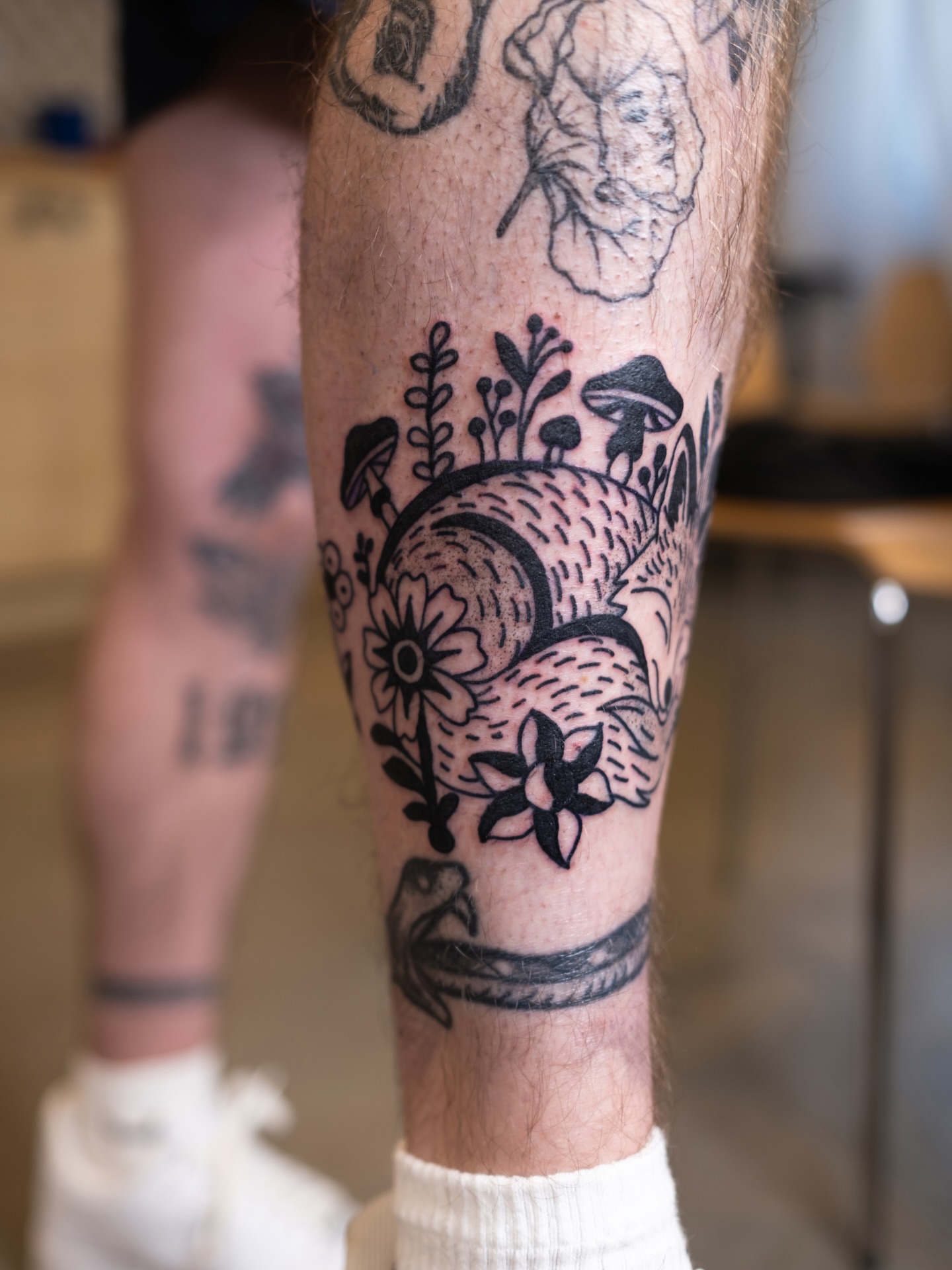 Flower and mushroom black and grey tattoo on the forearm by Neto Velasco - Sad Cat Tattoo, Austin, Texas