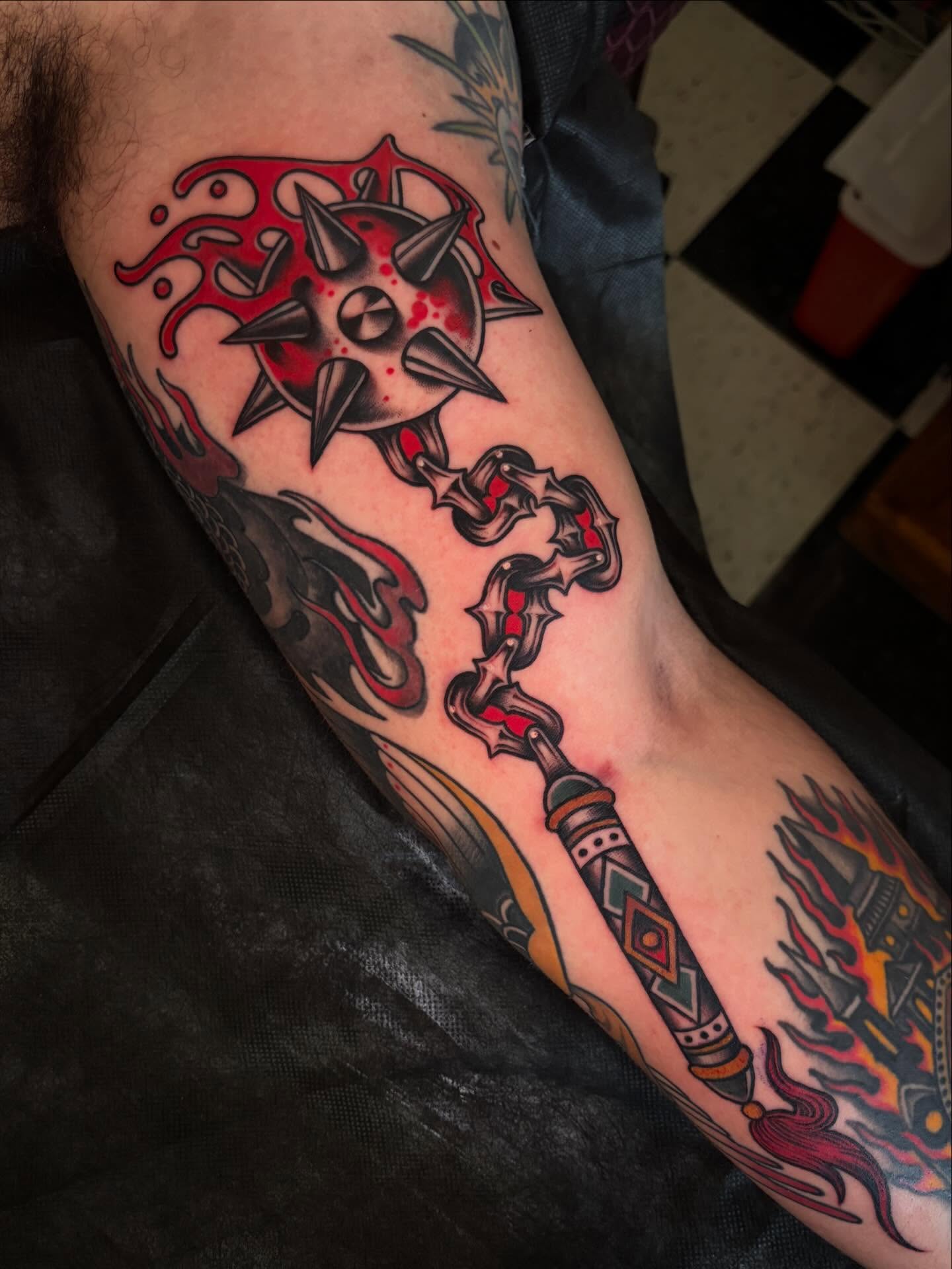 Spiked wheel and staff American traditional tattoo on the forearm by ๐ป๐๐๐ ๐ณ๐๐๐๐๐๐ ๐๐๐