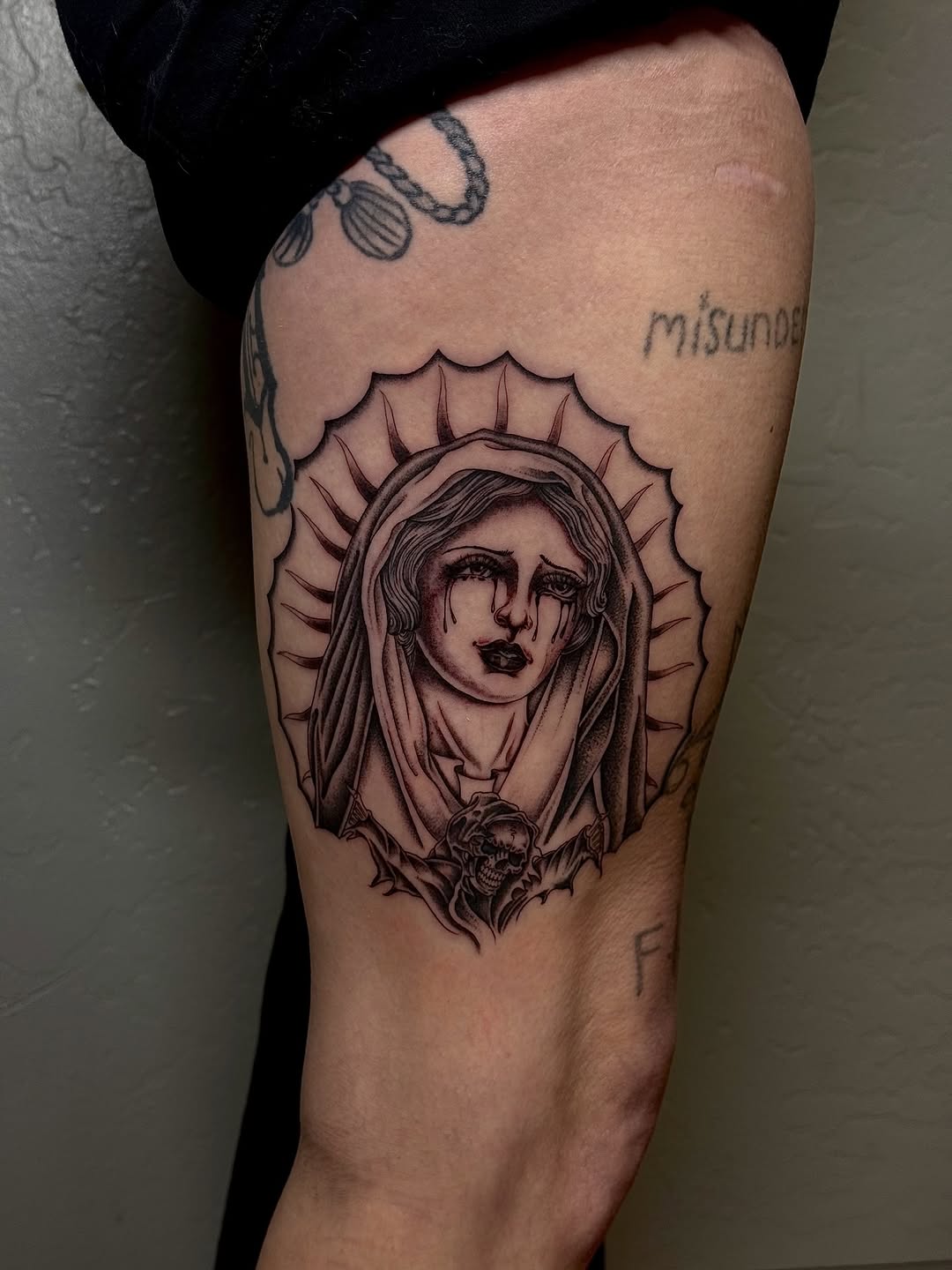 Crying virgin mary with skull realism tattoo on the thigh by Matthew Ulrich
