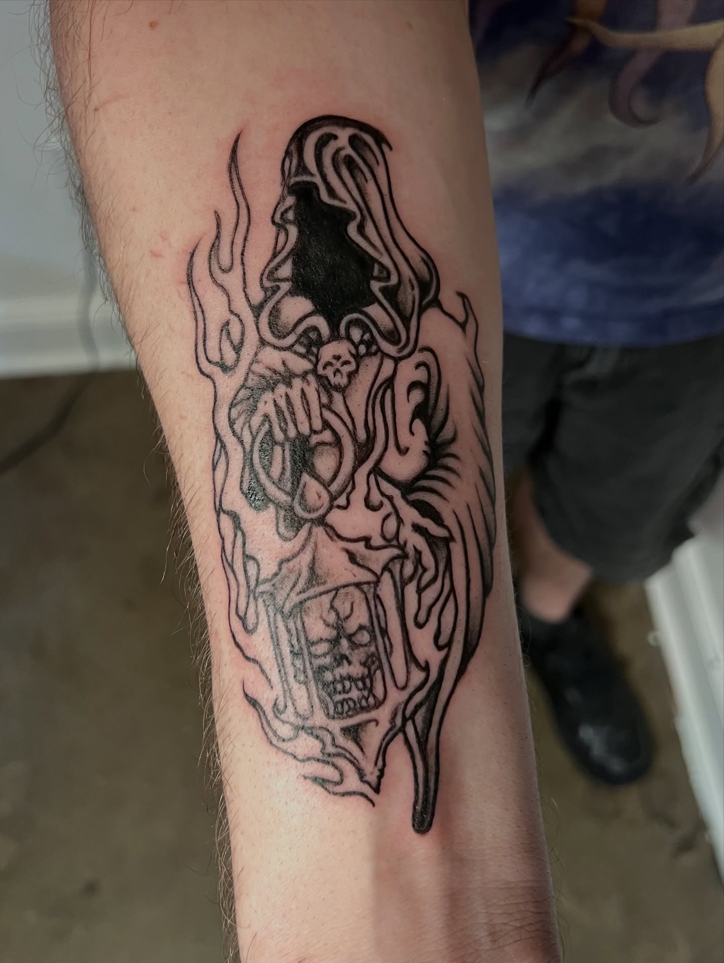 Ghostly figure black and grey tattoo on the forearm by ★𝐑𝐮𝐞★