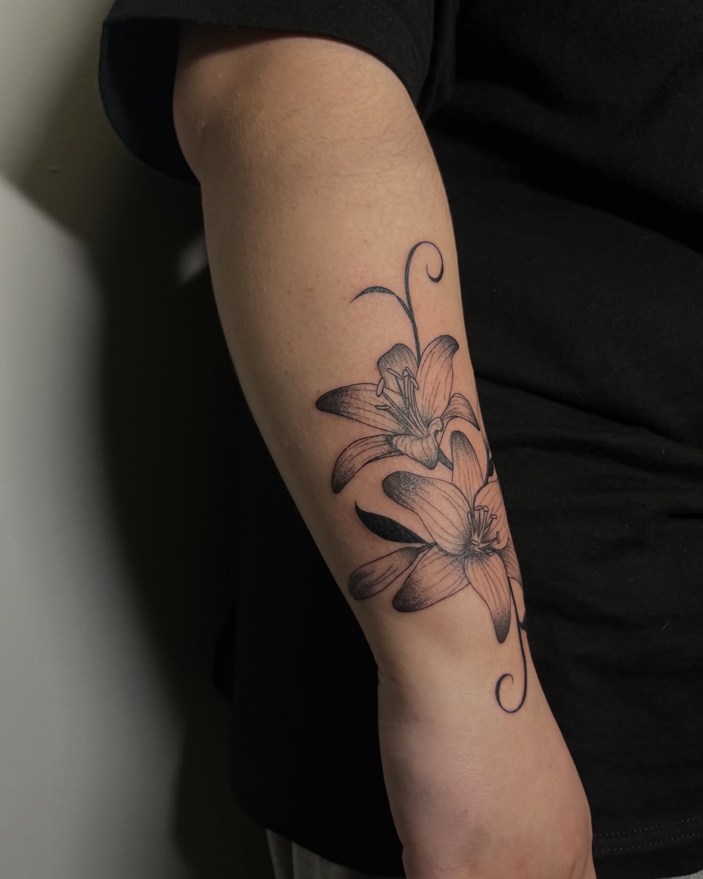 Lily dotwork tattoo on the forearm by Daniela