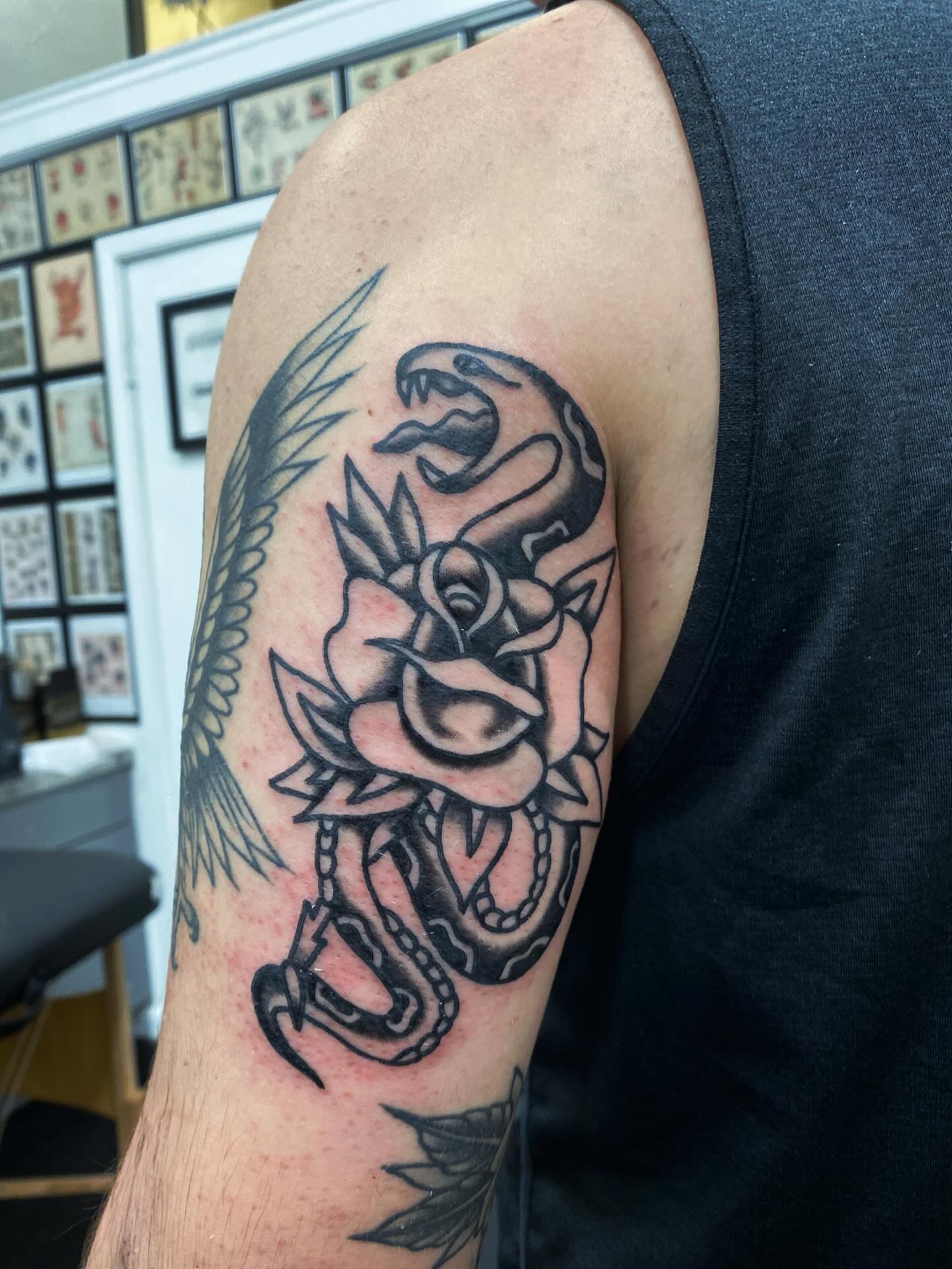 Snake and rose American traditional tattoo on the forearm by @rubber_band_dan, San Francisco, California