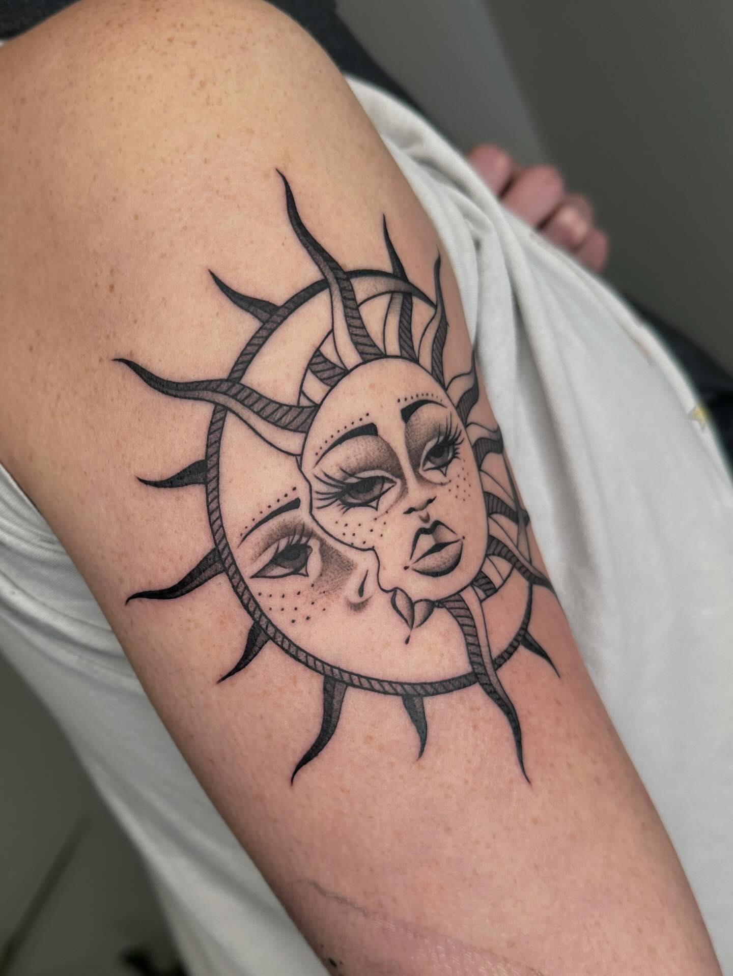 Sun with face realism tattoo on the forearm by Aleksandra