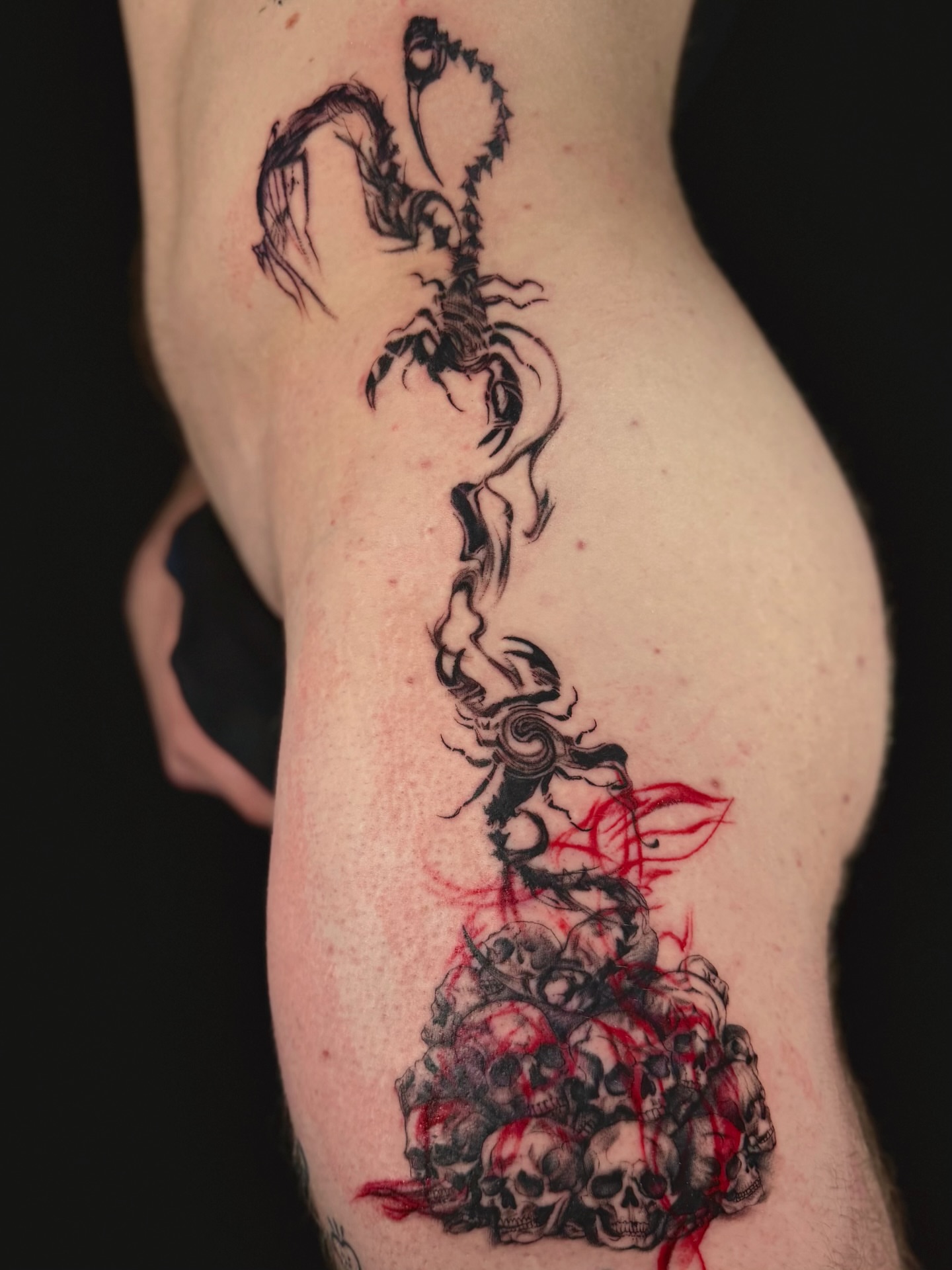 Scorpion and skulls dark realism tattoo on the thigh by Abi