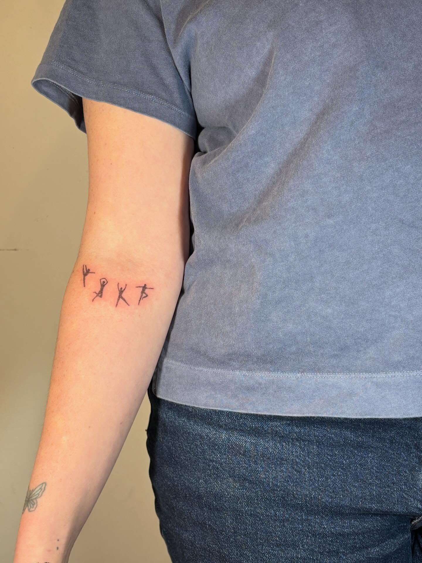 Stick figures minimalist tattoo on the forearm by Jill