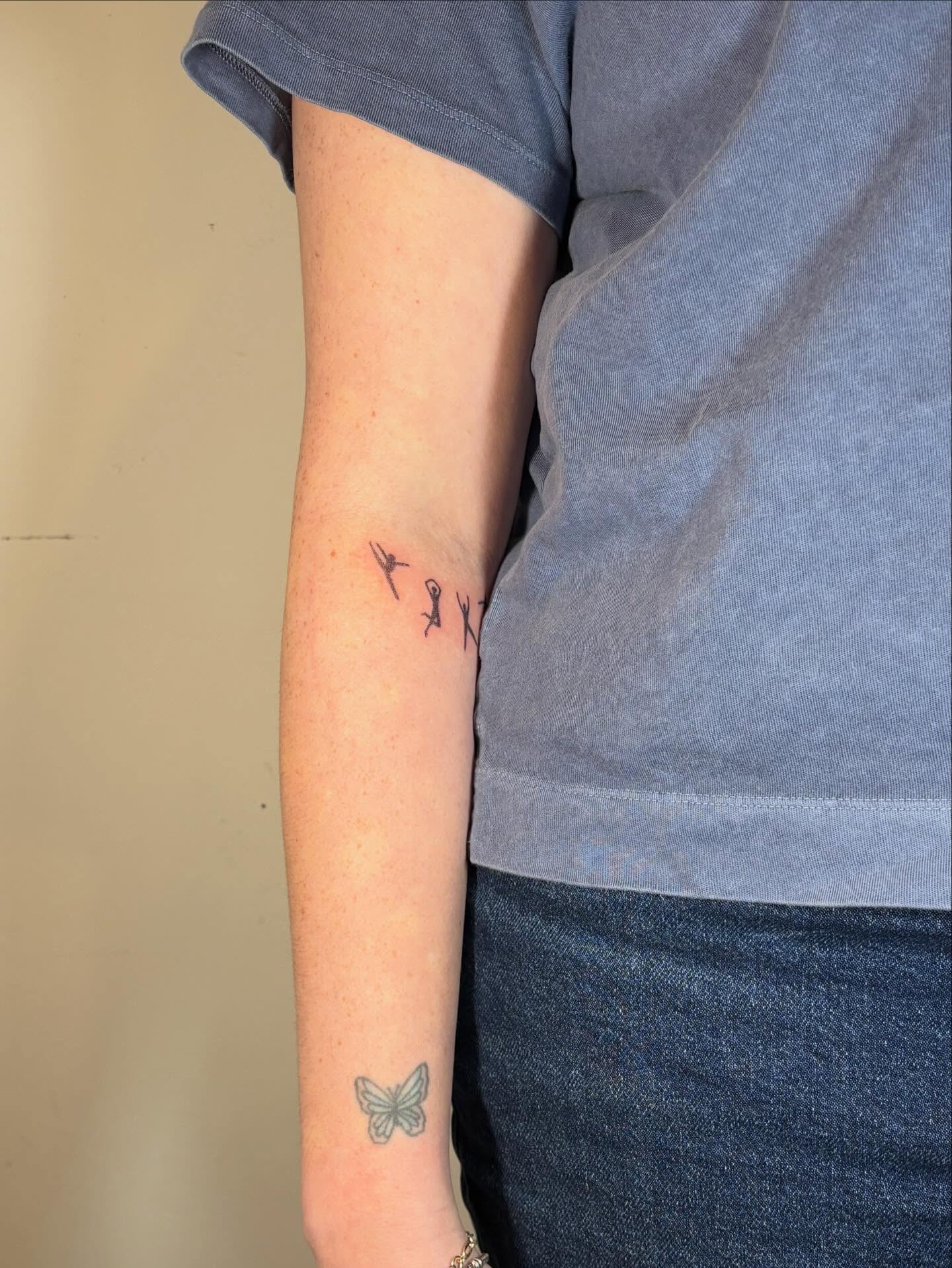 Family silhouettes black and grey tattoo on the forearm by Jill